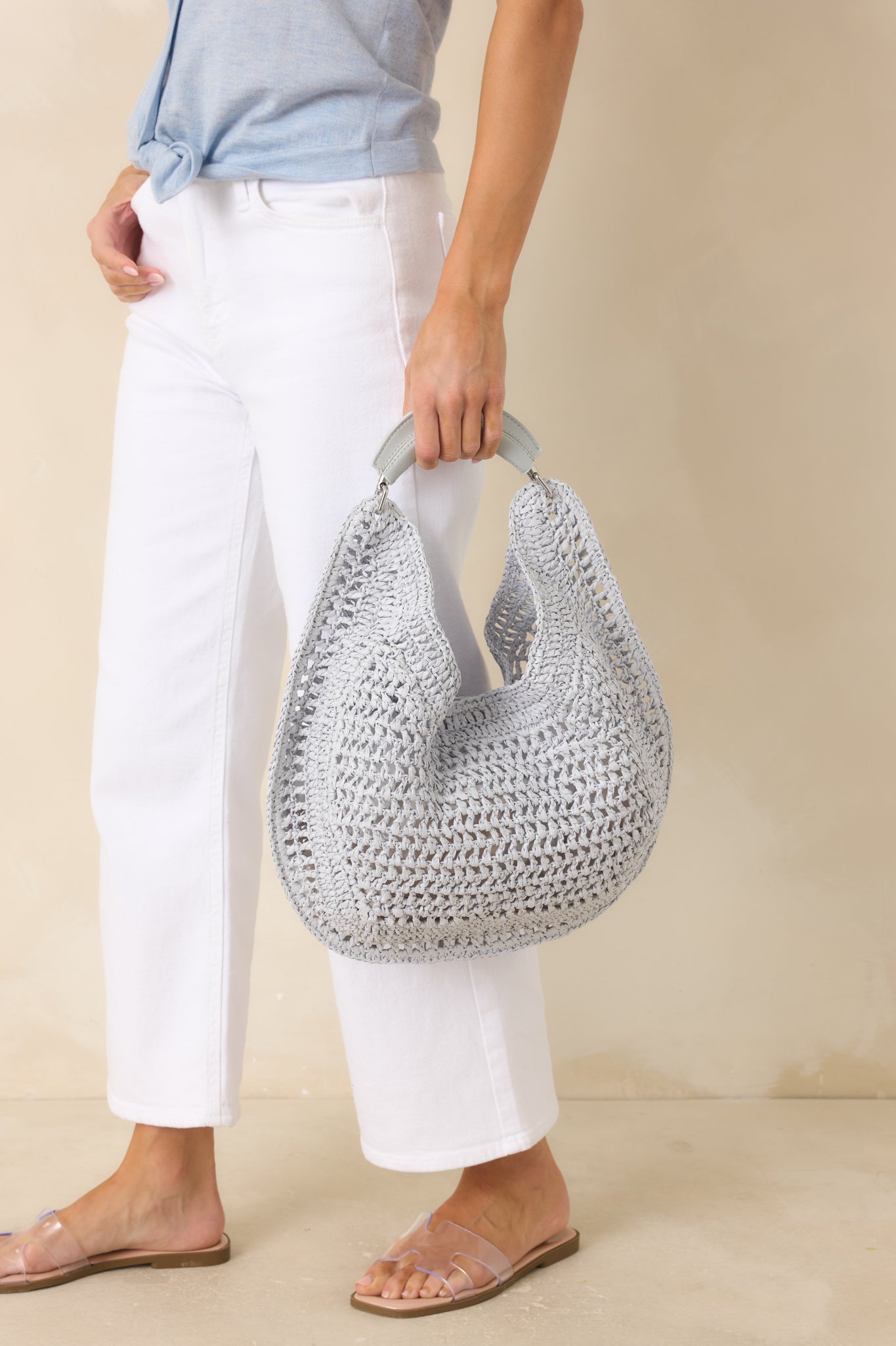 Soft blue hobo bag showcasing an airy woven texture, relaxed shape, and spacious everyday design.