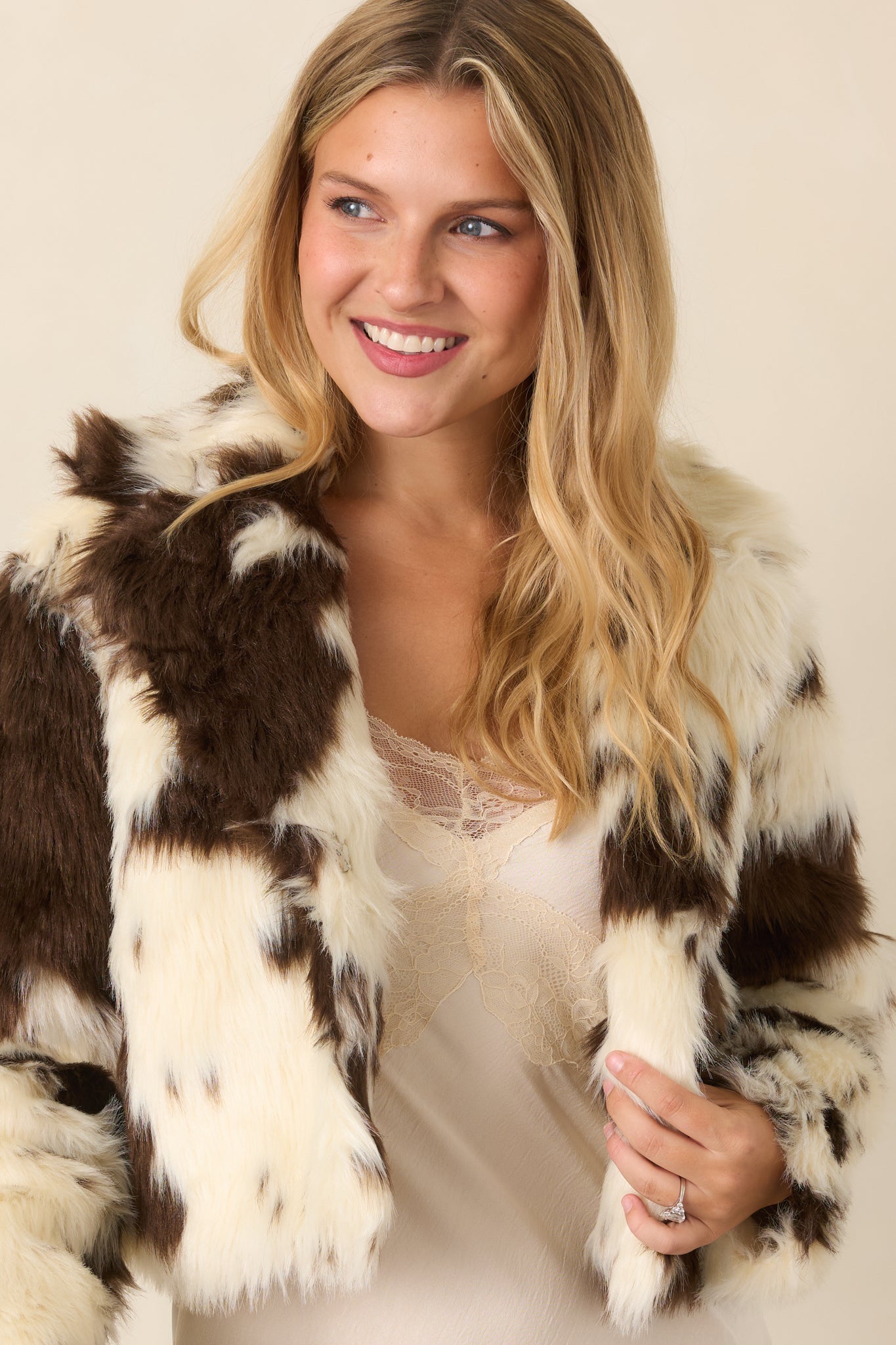 Bomber jacket detail showing a long sleeve, oversized collar, and neatly finished front closure.