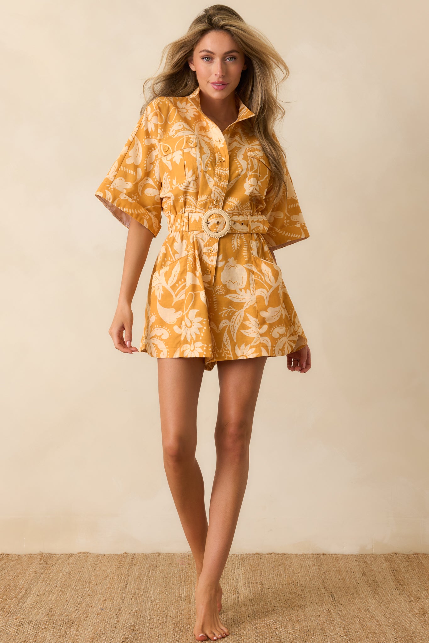 Botanical damask print romper crafted from a linen-cotton blend with a collared neckline, elasticized waist, and functional side pockets.