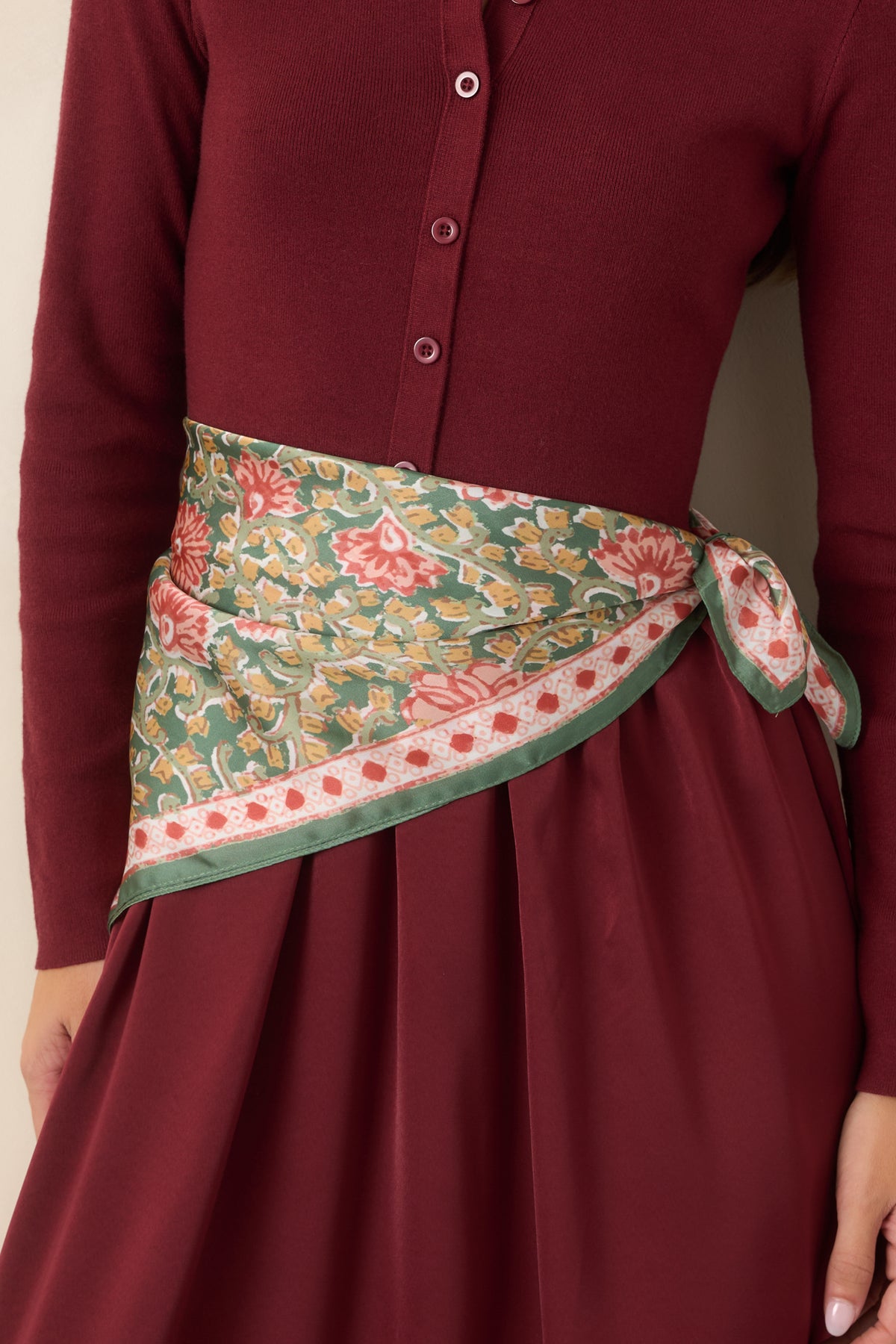 Botanical  scarf with colorful floral motifs and pale vines framed by a patterned coral and ivory border.