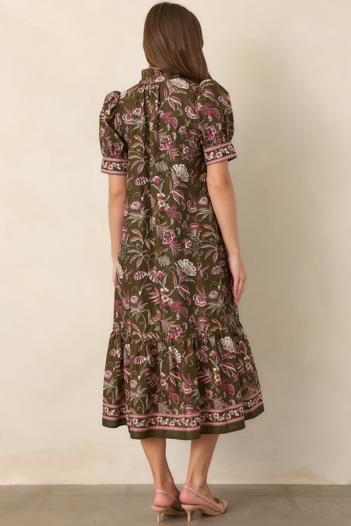 Close-up of the botanical floral print and decorative border detailing on the dress.
