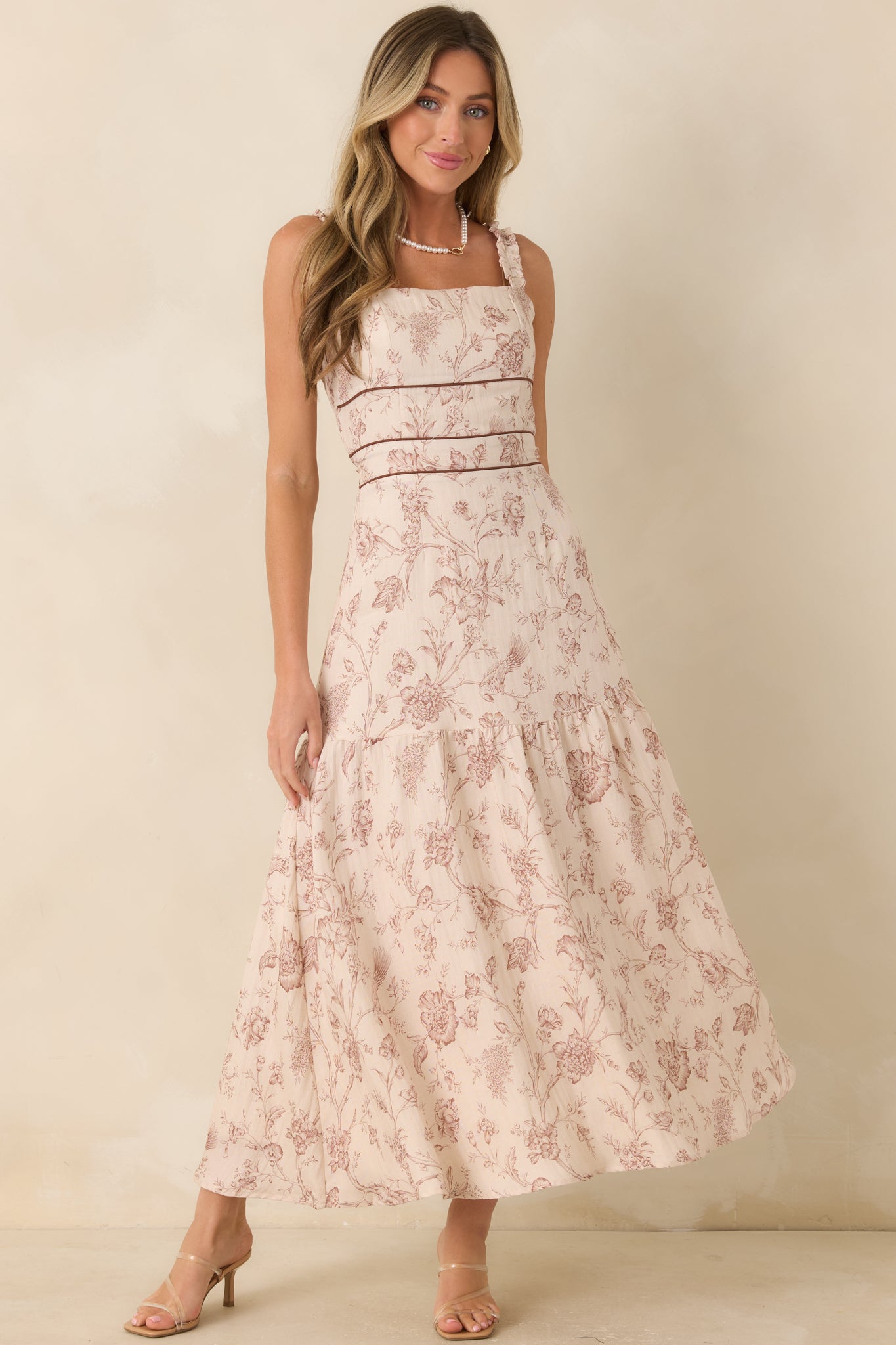 Lyocell-viscose blend maxi dress designed with a fitted bodice, defined waist, smocked back, and delicate floral-inspired print.