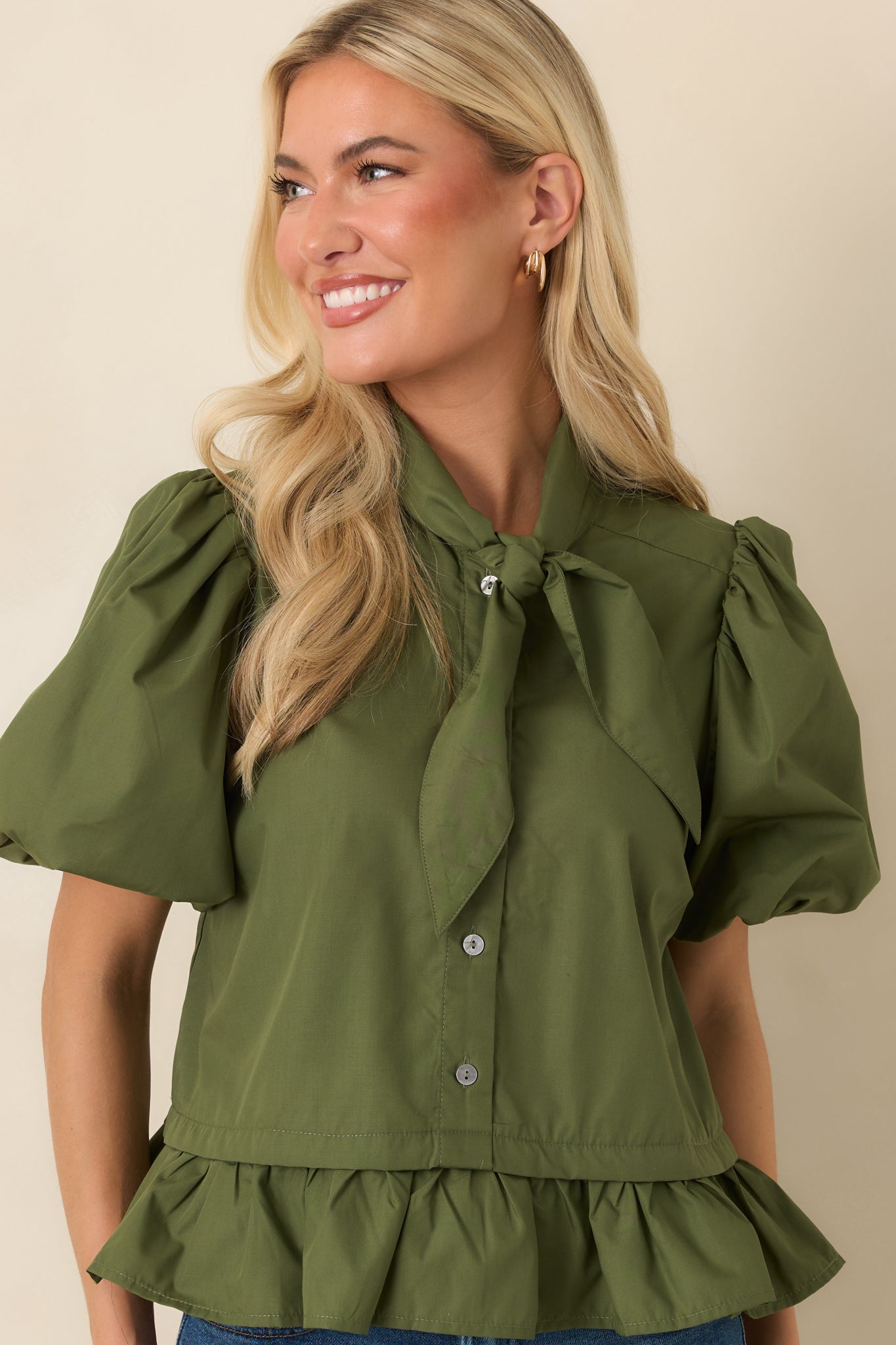 Close-up of the blouse highlighting the bow neckline, soft gathers, and elegant design elements.