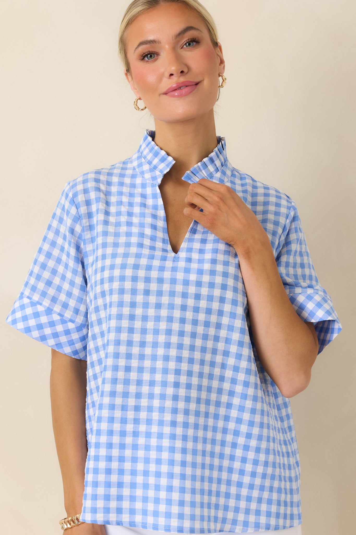 Boxy blue gingham top showing relaxed fit and casual silhouette.