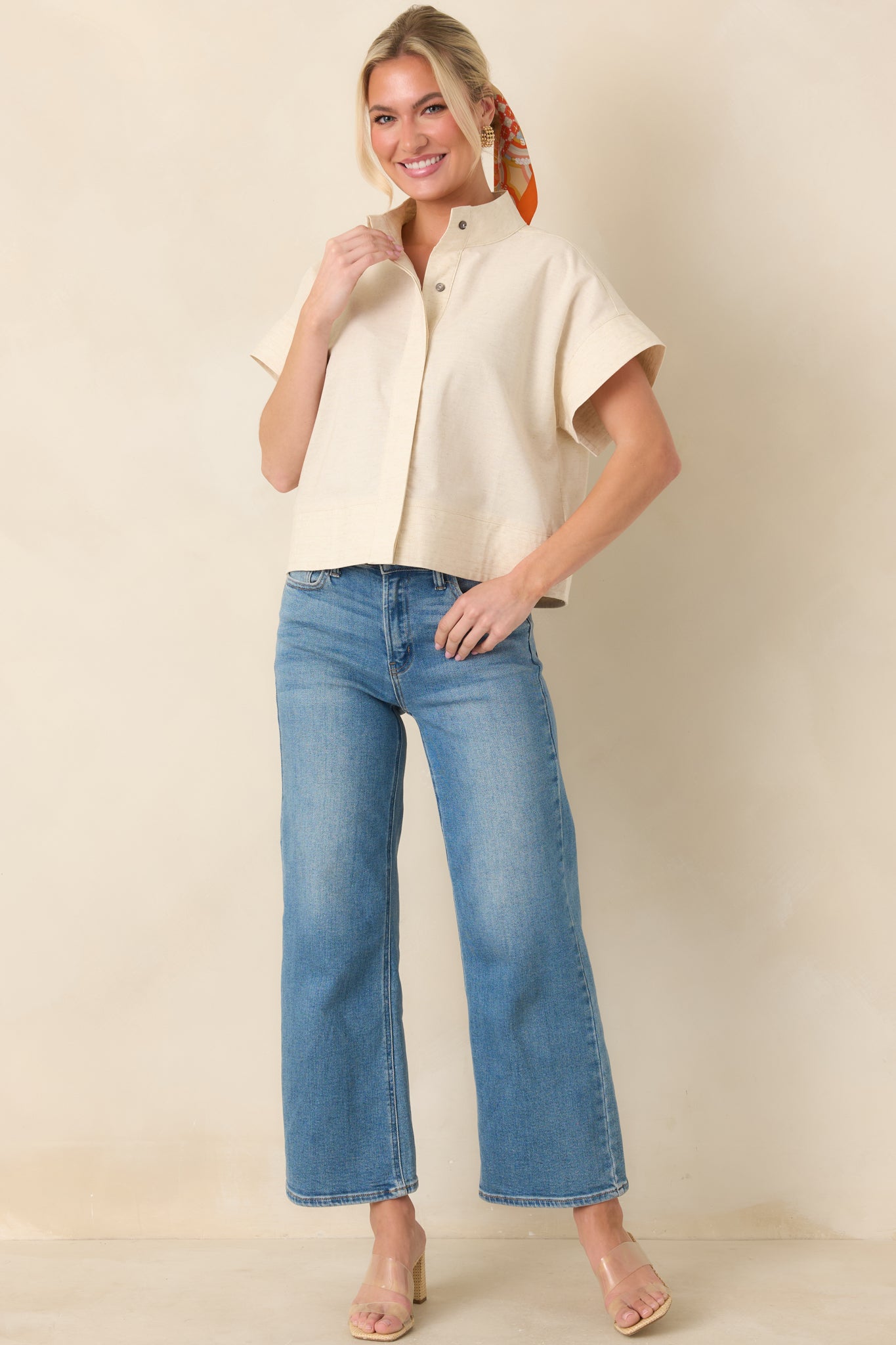 Boxy cotton linen top with wide cuffed short sleeves and straight hem.