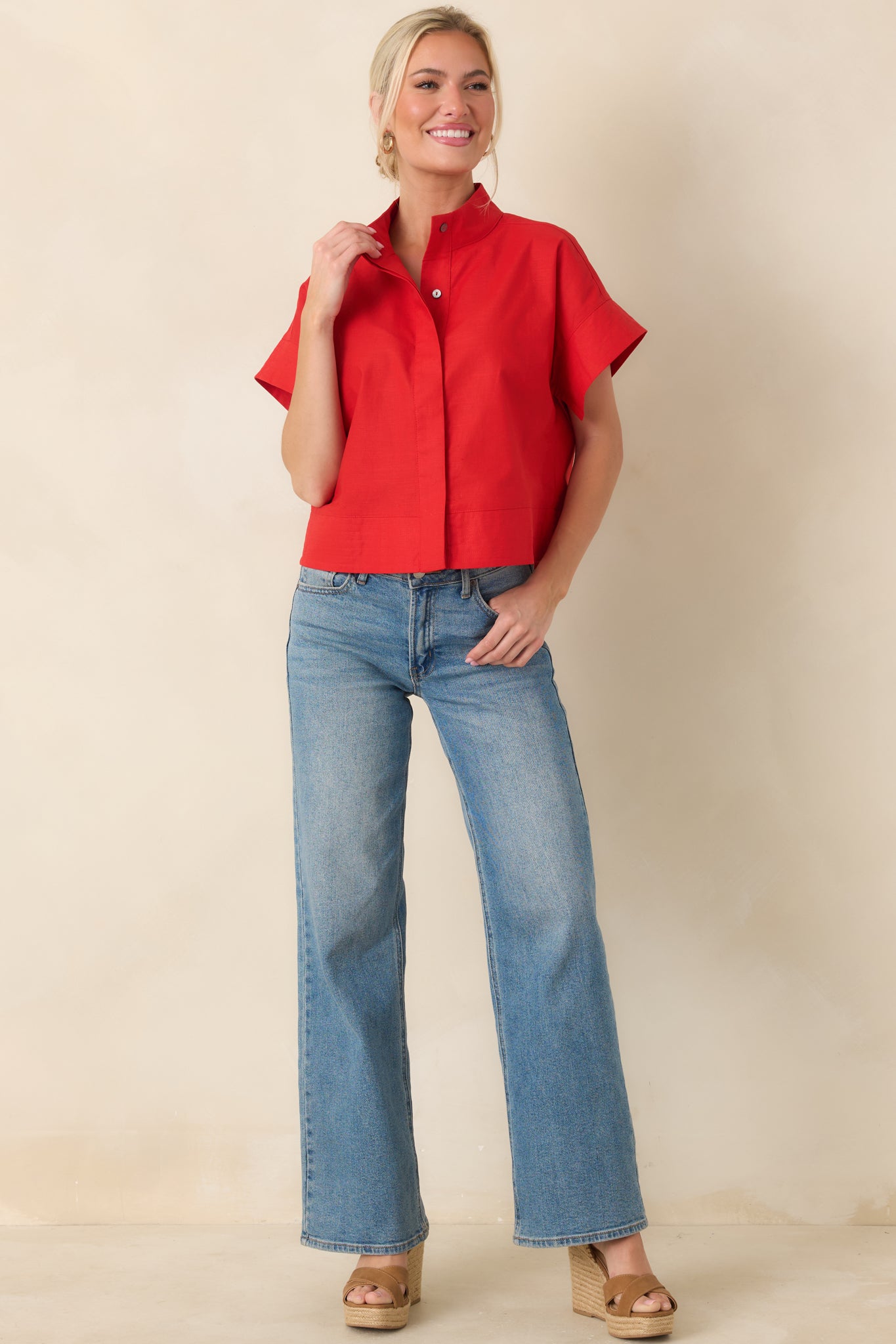 Boxy red woven top with clean, streamlined front and lightweight breathable fabric.