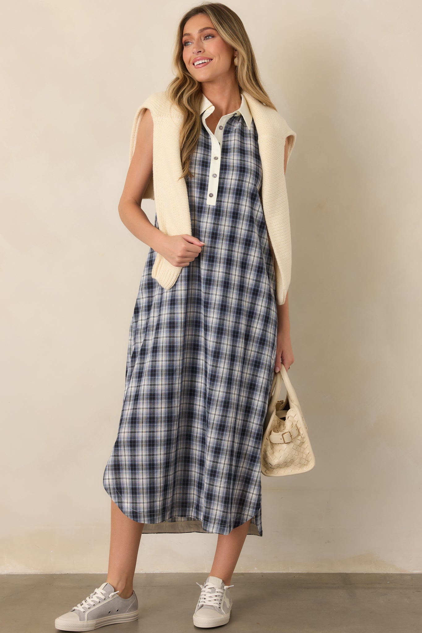 Breathable cotton dress with a sleeveless cut, crisp collar, partial button placket, contrasting ivory trim, relaxed shape, and side pockets.
