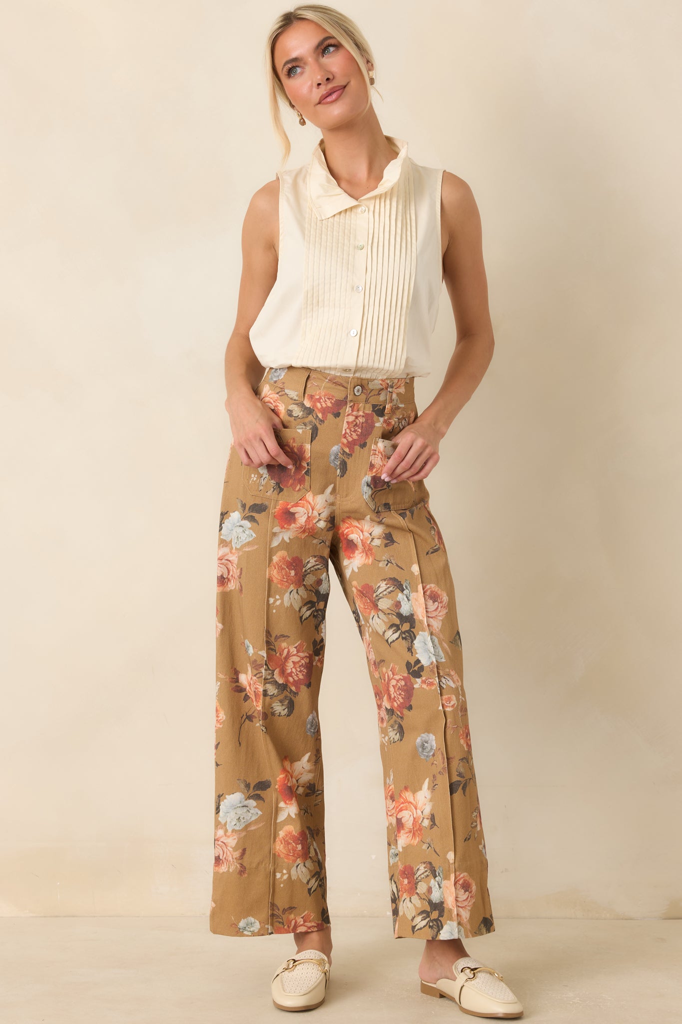 Breathable 100% cotton top with crisp pleated accents, a tailored collar, and a timeless button-front finish.
