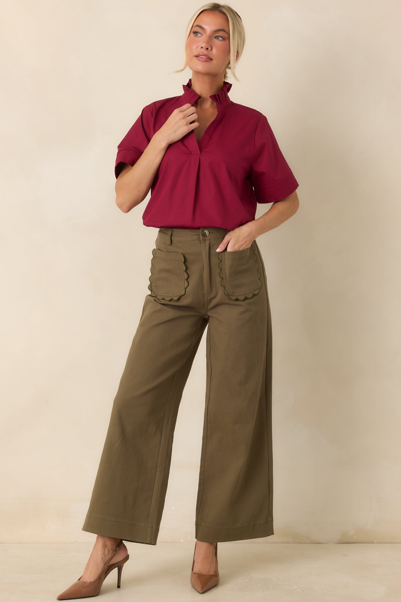 Breathable cotton top showcasing a split neckline, structured collar detail, and short sleeves with polished cuff accents.