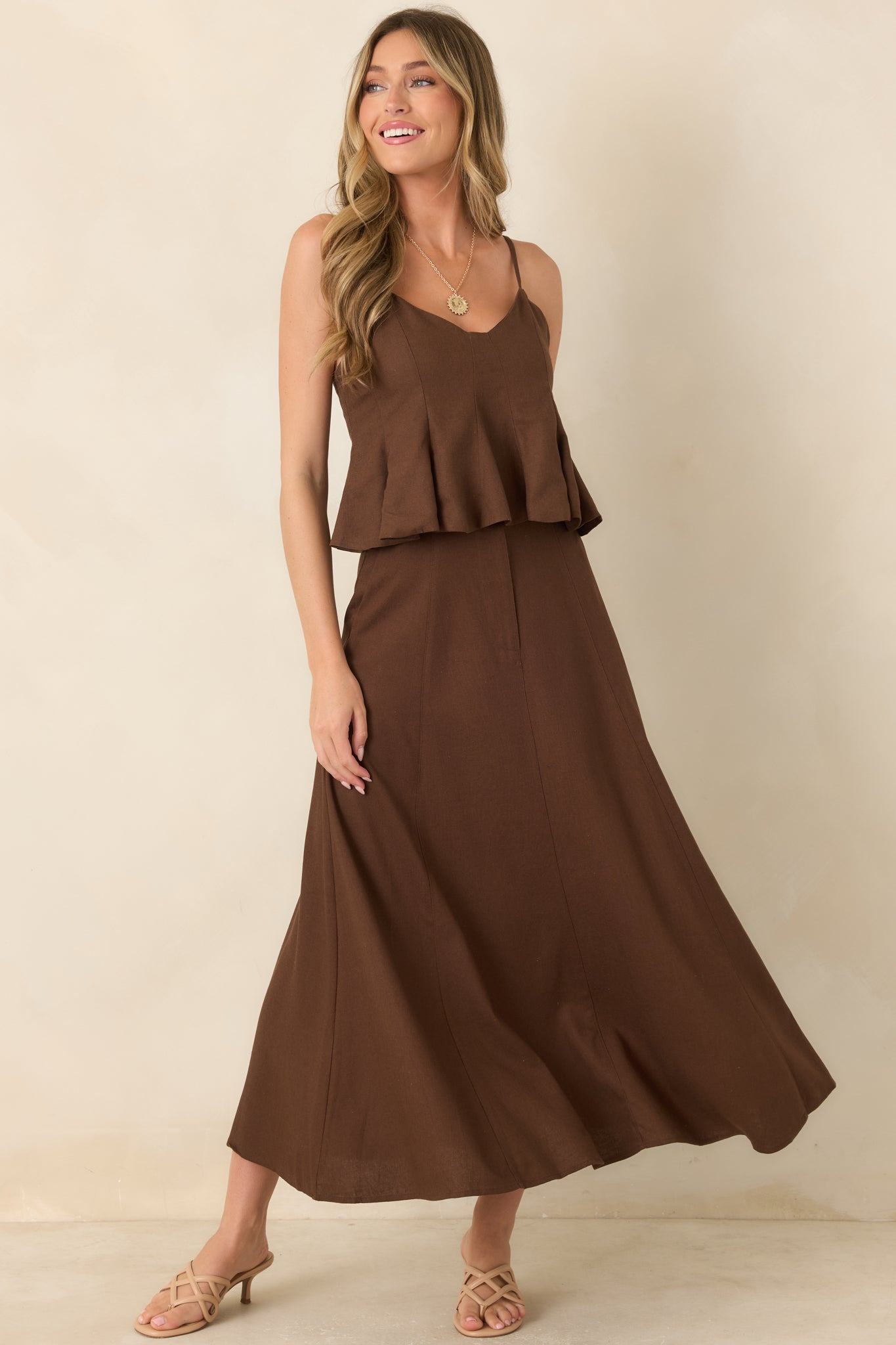 Breathable linen blend skirt with a tailored high-rise waist, paneled construction, concealed front zipper, and flowing A-line shape with side pockets.
