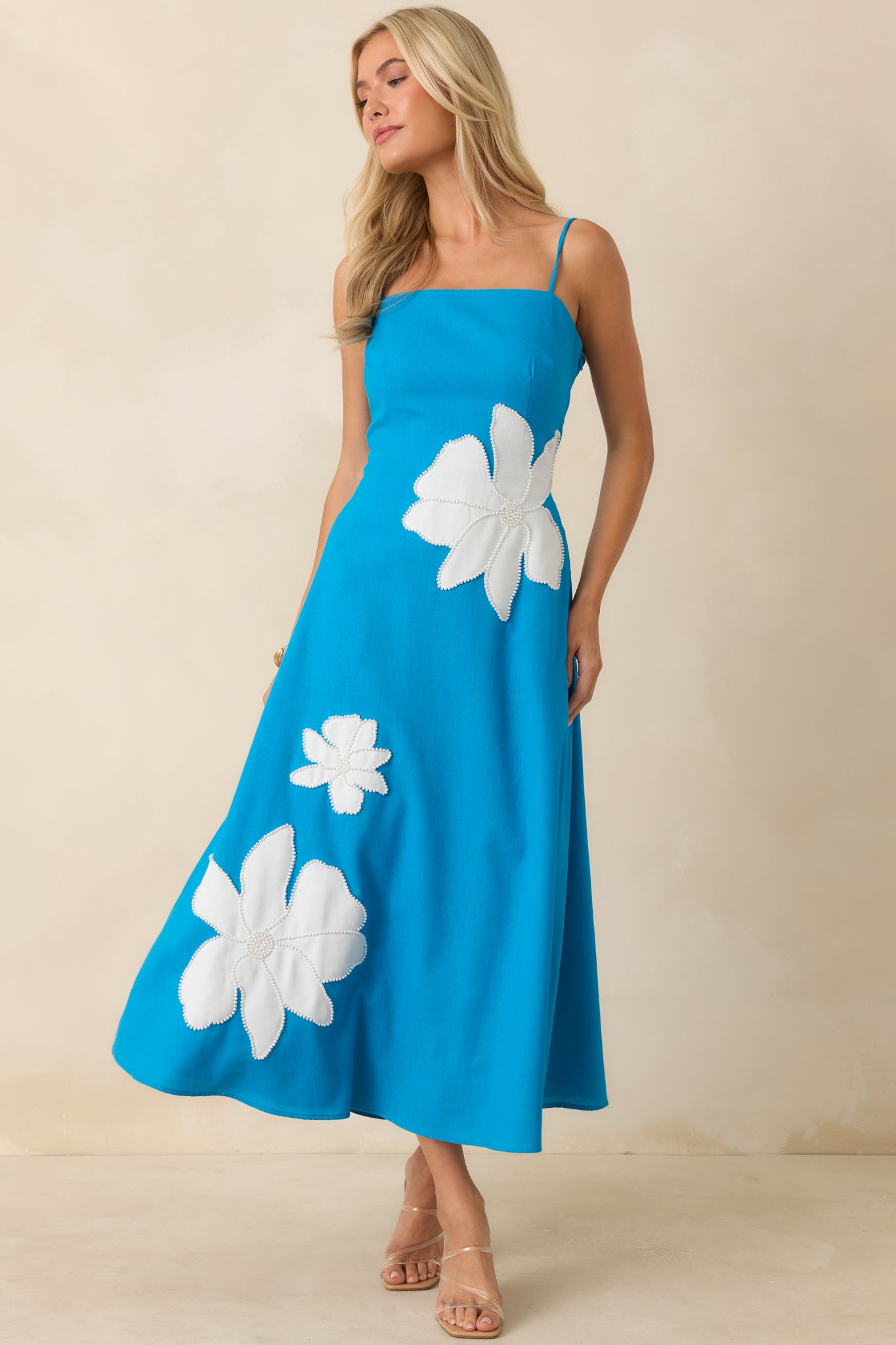 A-line midi dress crafted from breathable linen-blend fabric with a fitted bodice, full lining, and functional side pockets.