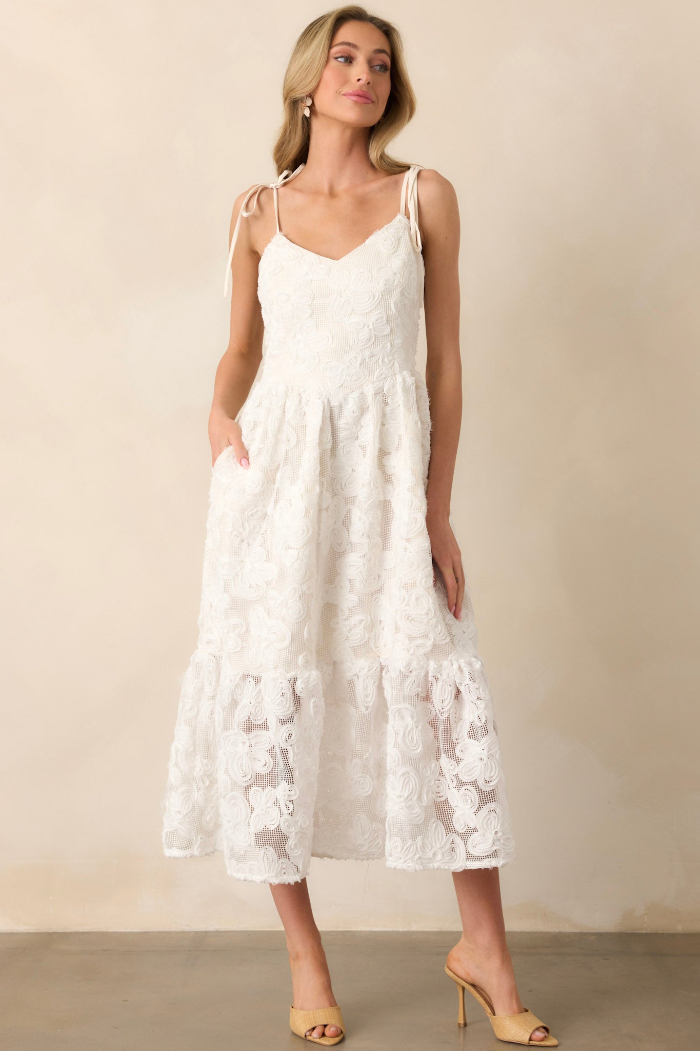 A breezy maxi dress with a 3D floral lace design, flowing silhouette, and practical pockets. The lace overlay adds movement and texture to the overall look.