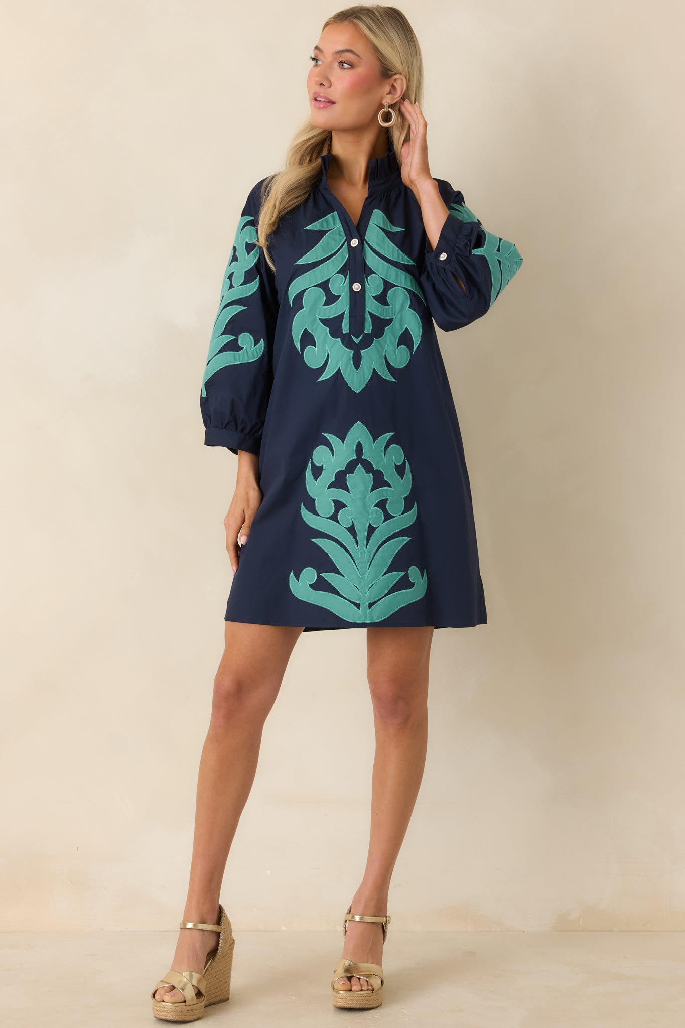 Breezy mini dress with bold contrast trim and relaxed, elevated silhouette.
