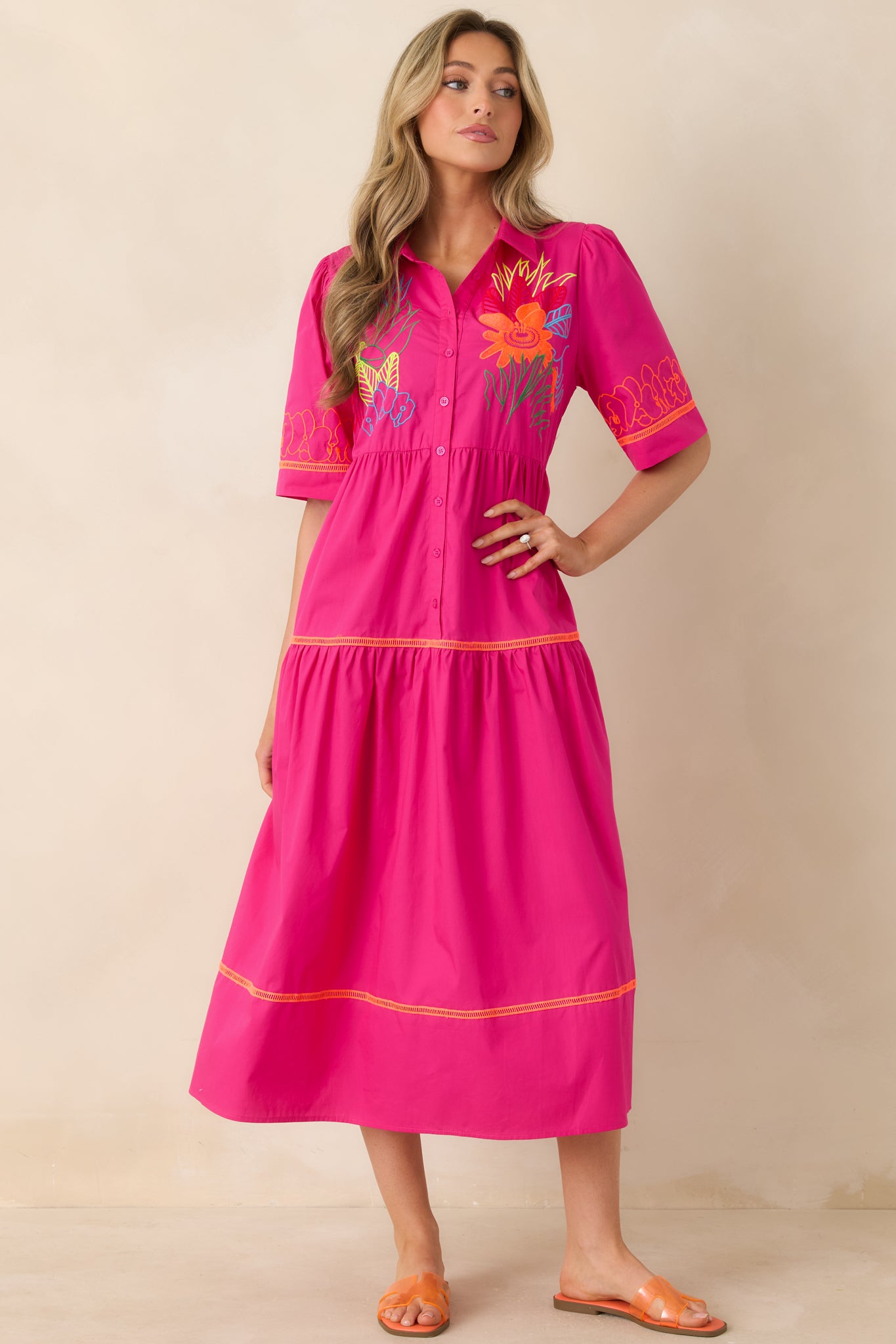 Breezy tiered dress featuring colorful fabric, collar, and front buttons.
