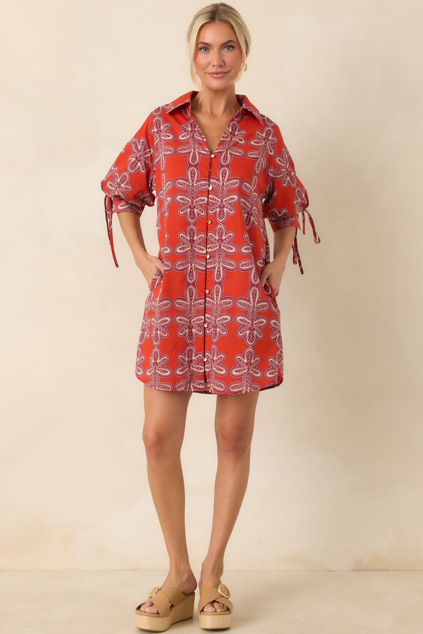 Relaxed-fit mini shirt dress showcasing a brick red and burgundy print, collared neckline, and playful puff sleeves.