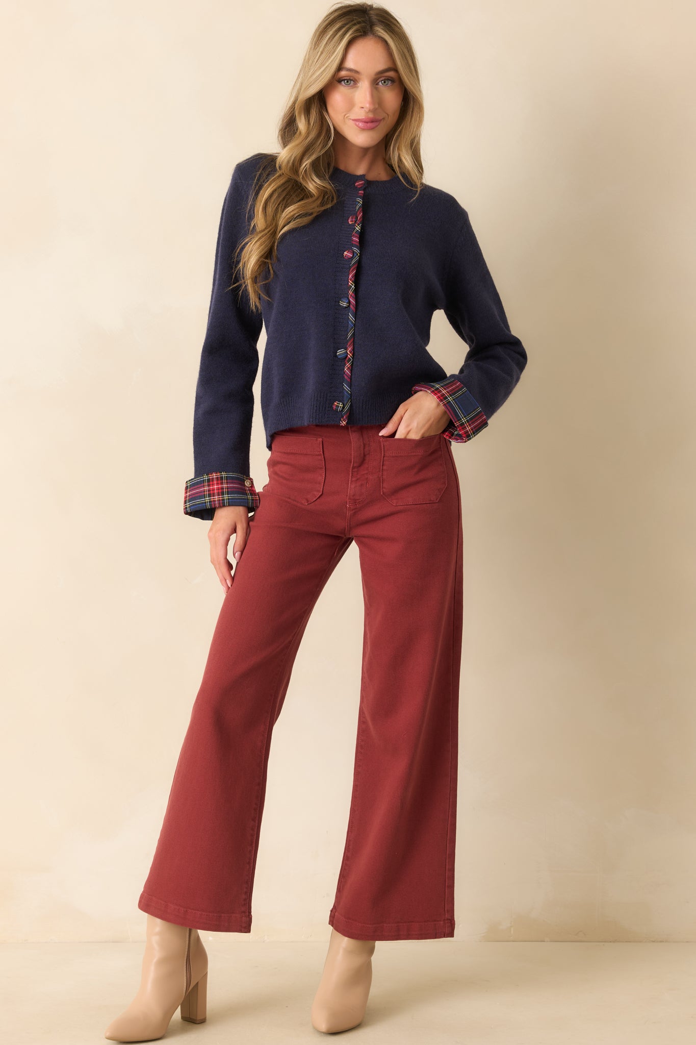 Brick red denim jeans with a high-rise waist, wide leg silhouette, and functional front and back patch pockets.