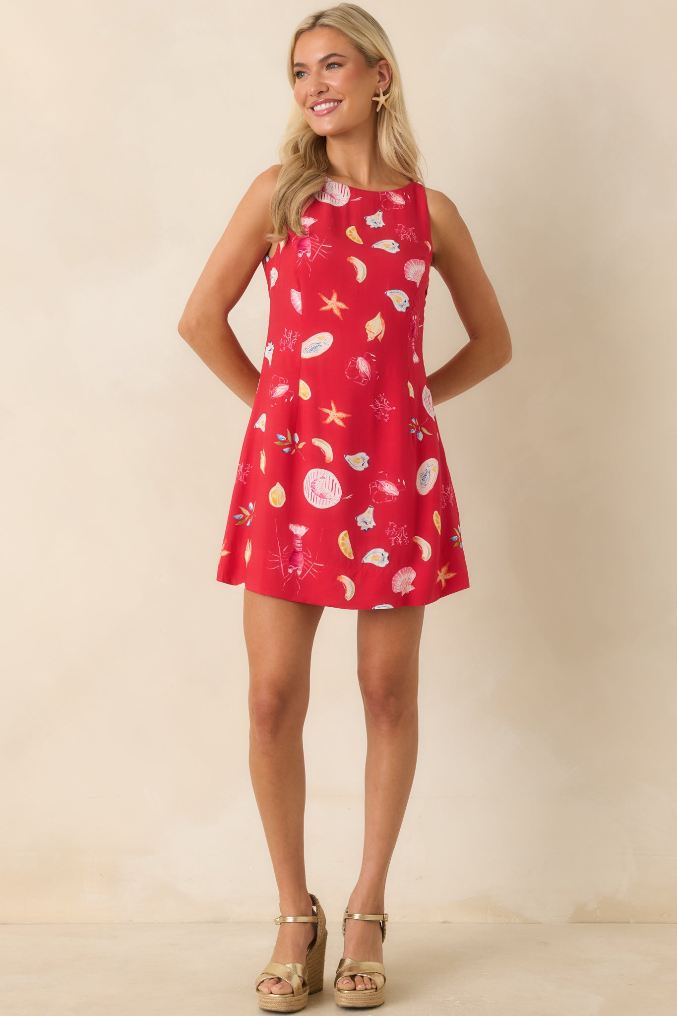 Bright red mini dress featuring a relaxed silhouette and playful seaside-inspired allover print.
