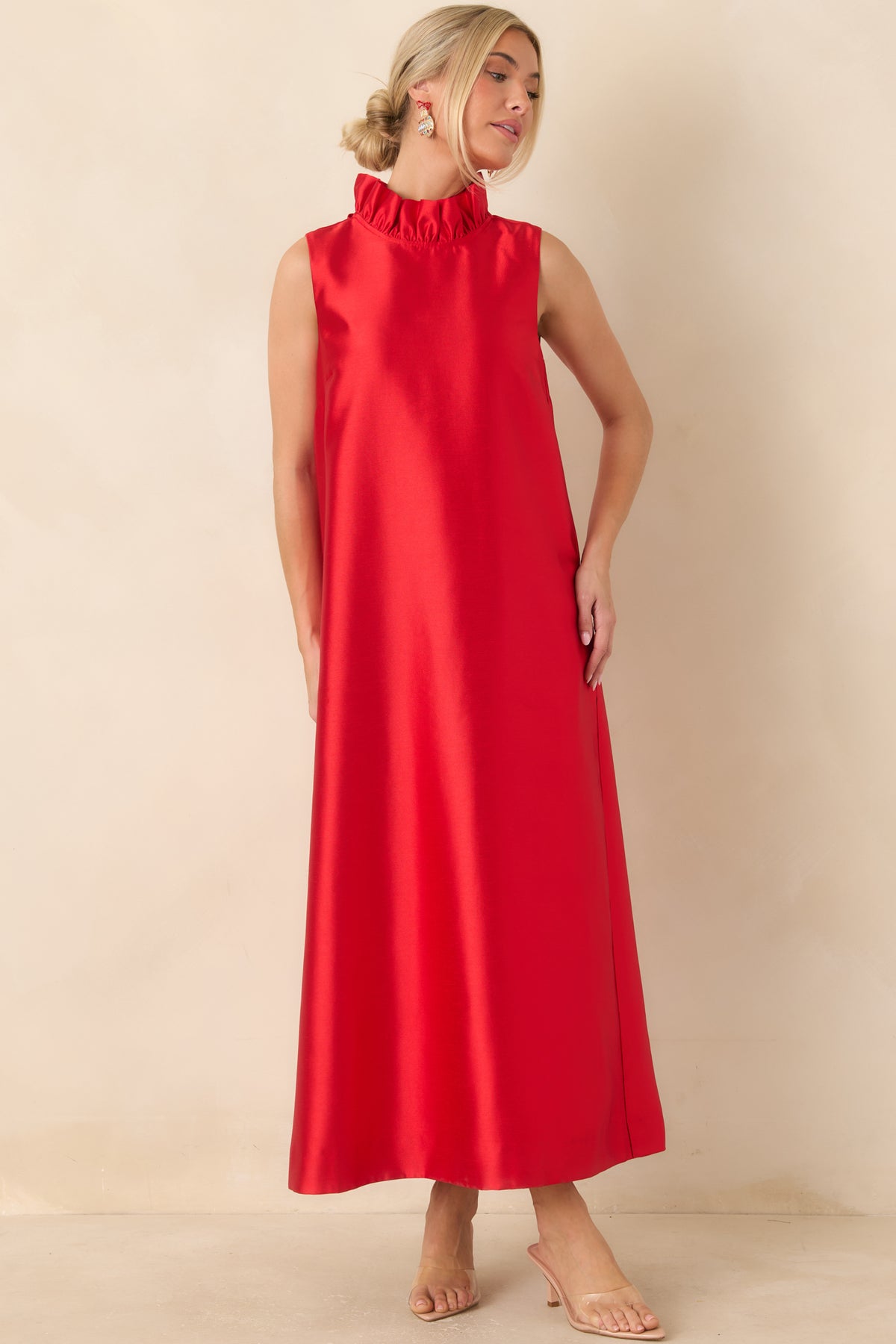 Bright red maxi dress featuring a ruffled mock neckline, sleeveless design, and a flowing straight silhouette.