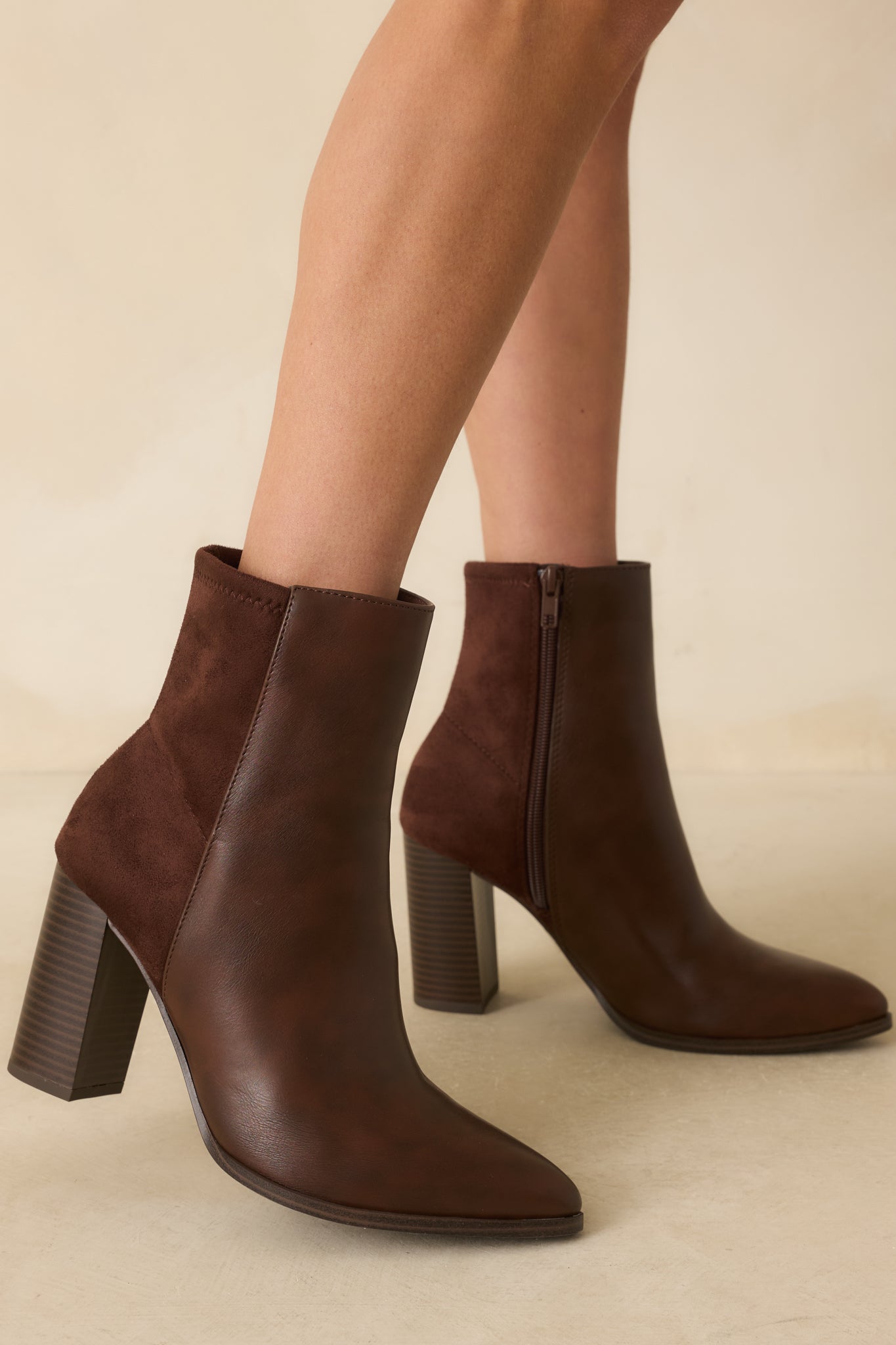 Brown ankle boot with smooth faux leather front, pointed toe, and stacked block heel.