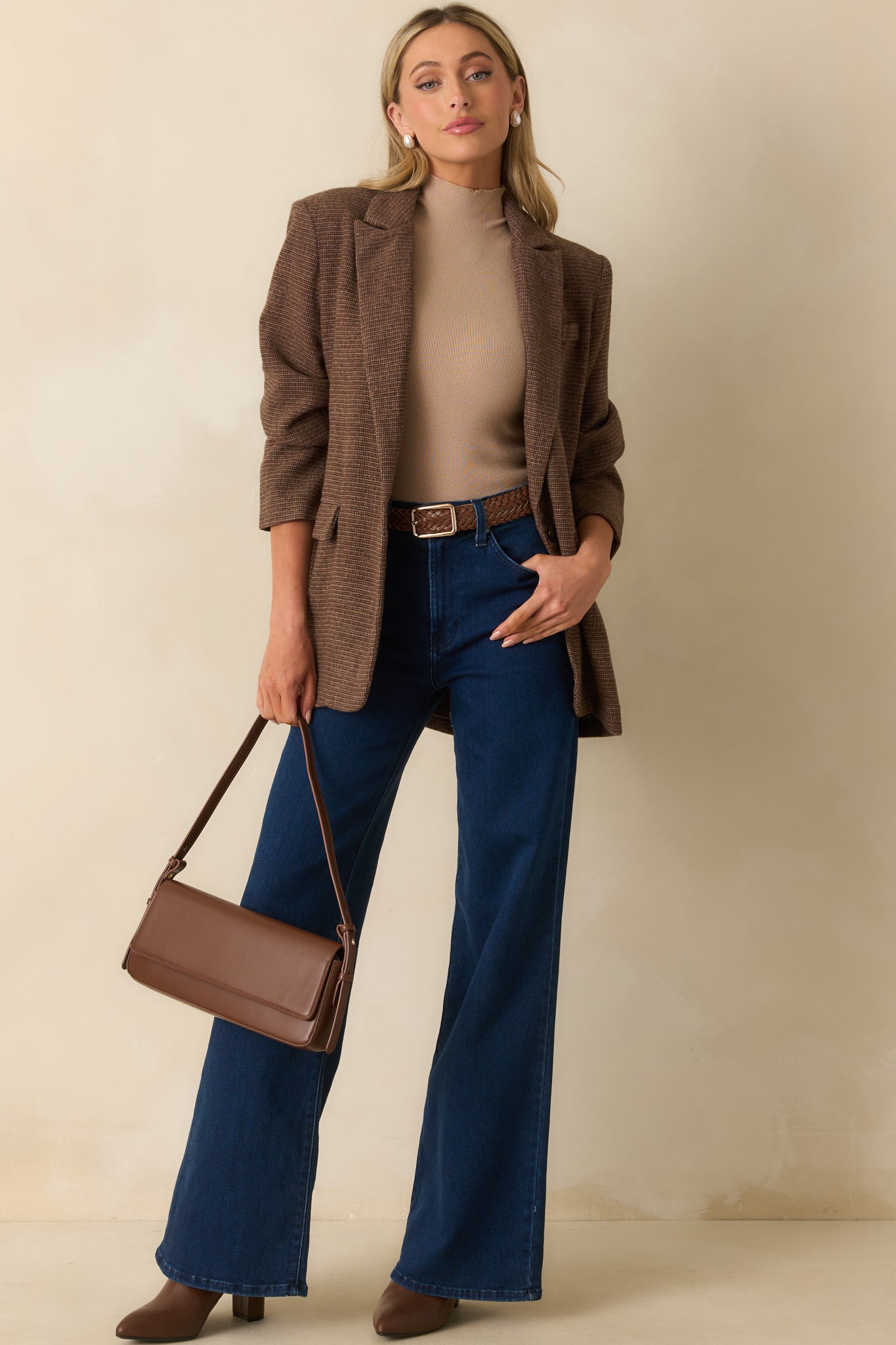 Tailored brown blazer with vented back hem and sleek single-breasted closure.