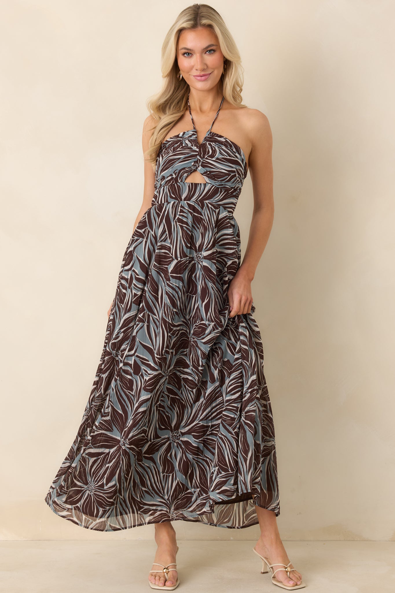 Brown and blue floral halter maxi dress with twisted front bodice and small keyhole cutout.