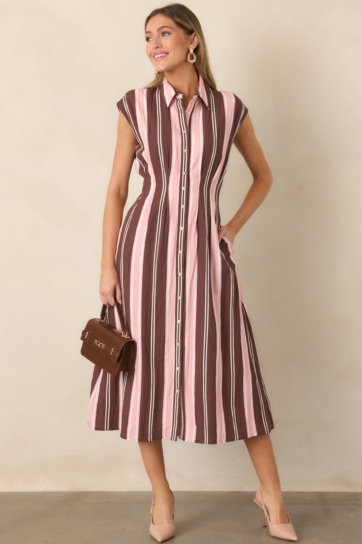 Polished midi dress showcasing soft brown, blush pink, and ivory vertical stripes, a button-front bodice, collared neckline, and feminine flared shape.