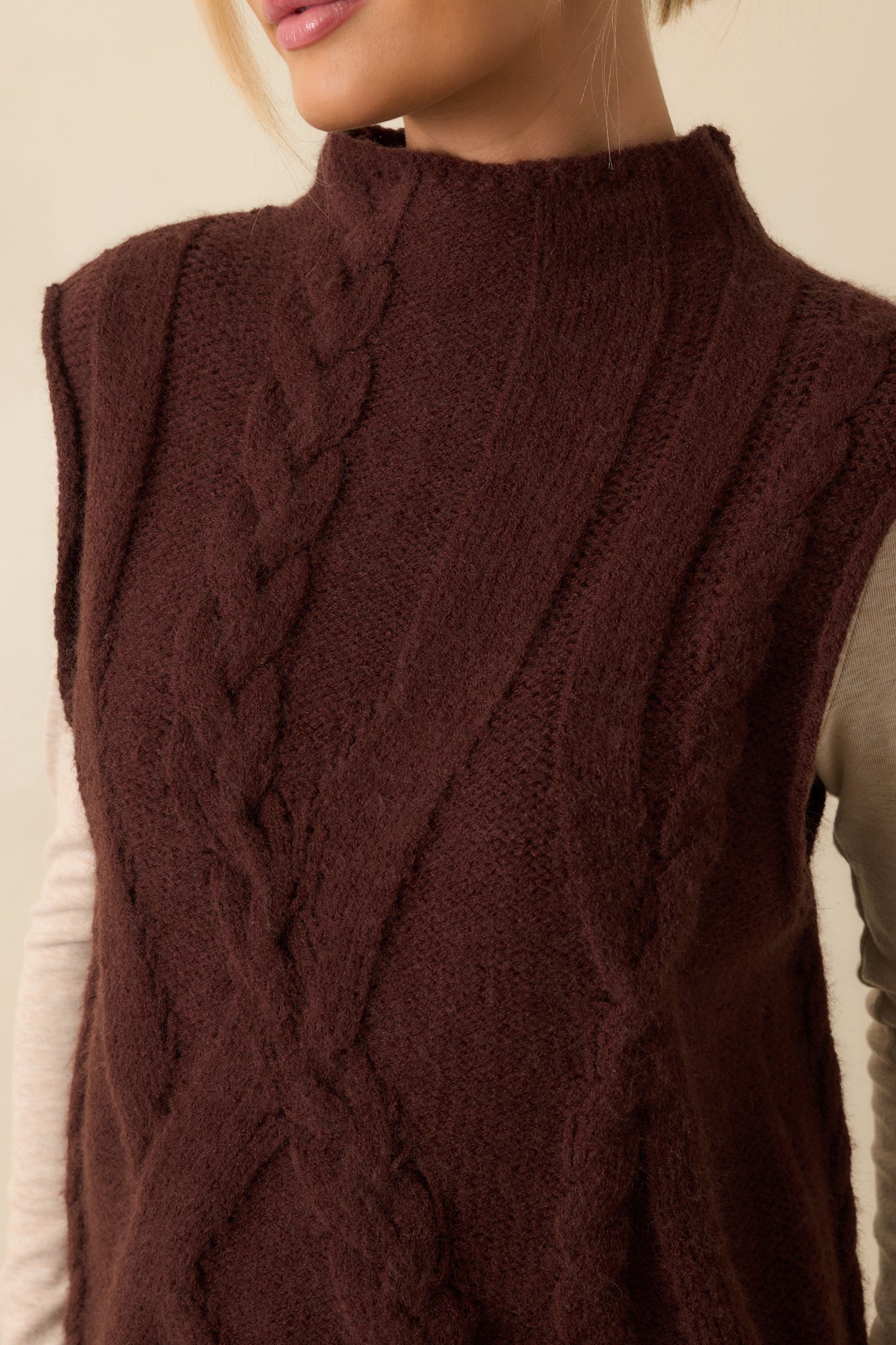 Close-up of the brown cable knit pattern and ribbed trim, emphasizing the soft knit texture.