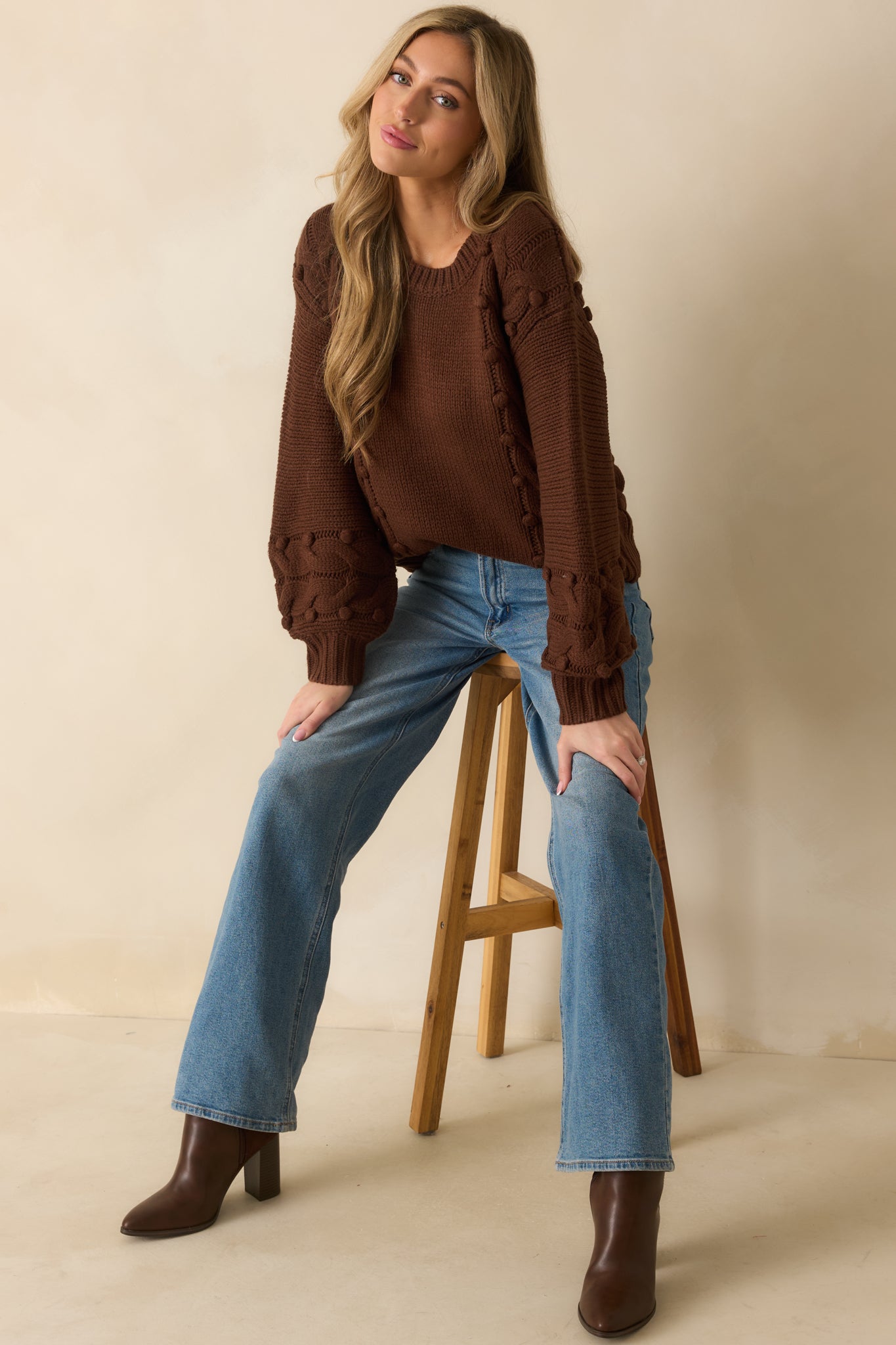 Brown cable knit sweater featuring bobble details across the knit and long sleeves.