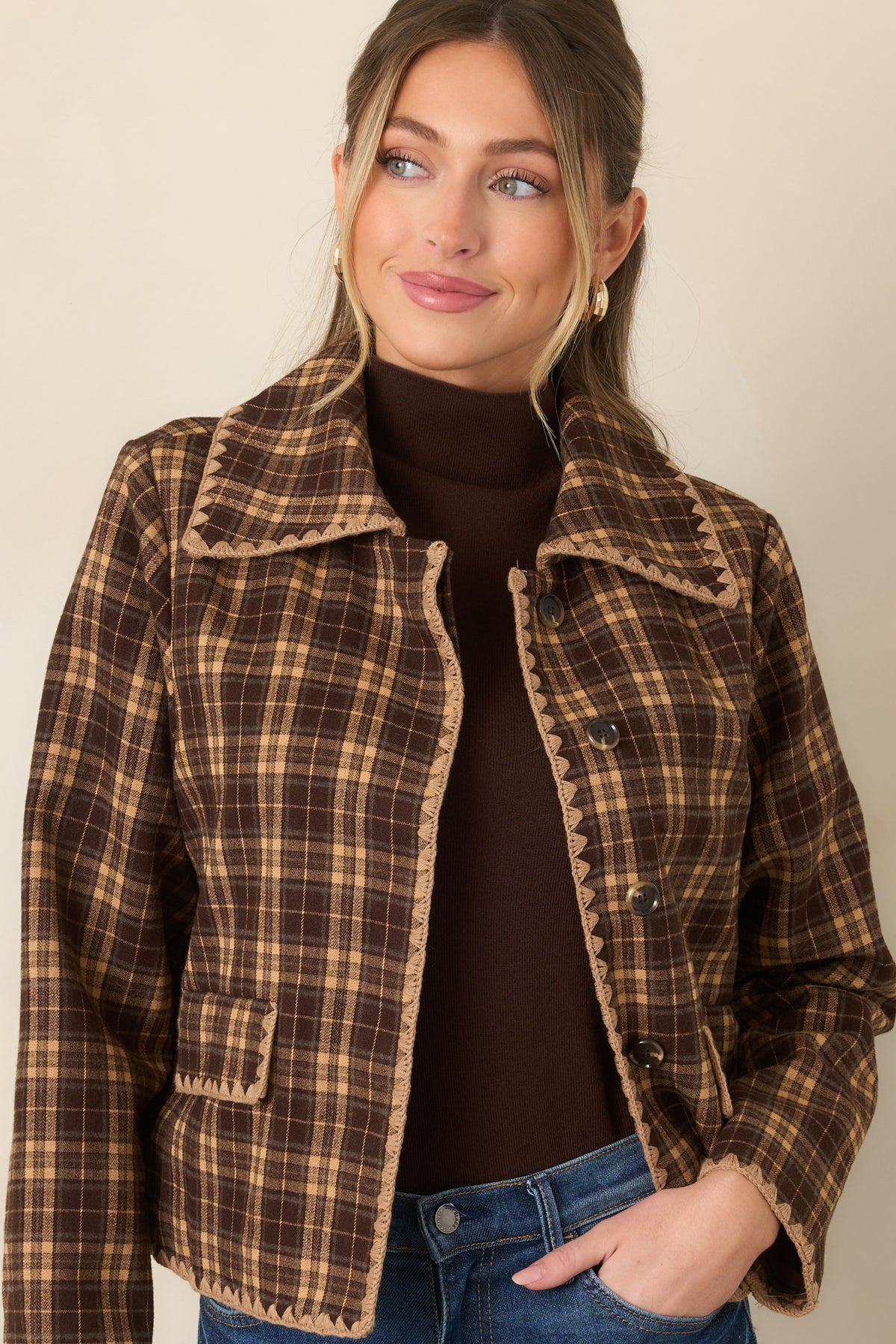 Structured brown and camel plaid jacket highlighting the collared neckline, tonal buttons, and scalloped button placket.