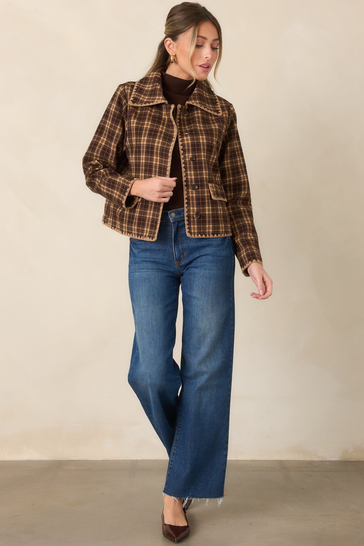 Brown and camel plaid jacket featuring a collared neckline, tonal buttons, scalloped contrast stitching, and front pockets.
