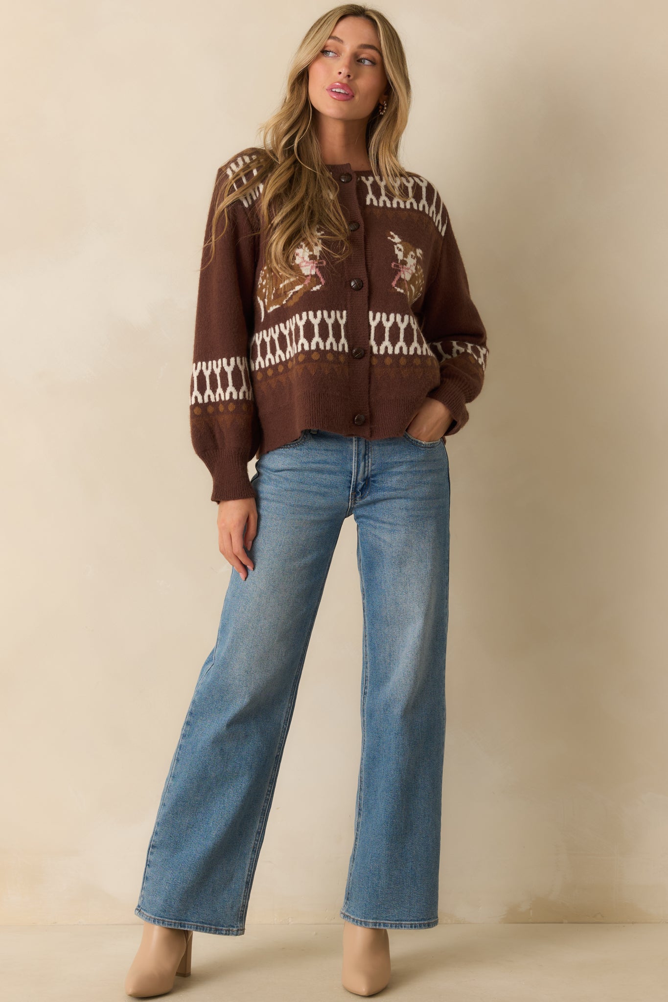 Brown cardigan with ivory and tan geometric intarsia knit and deer motifs across the front.
