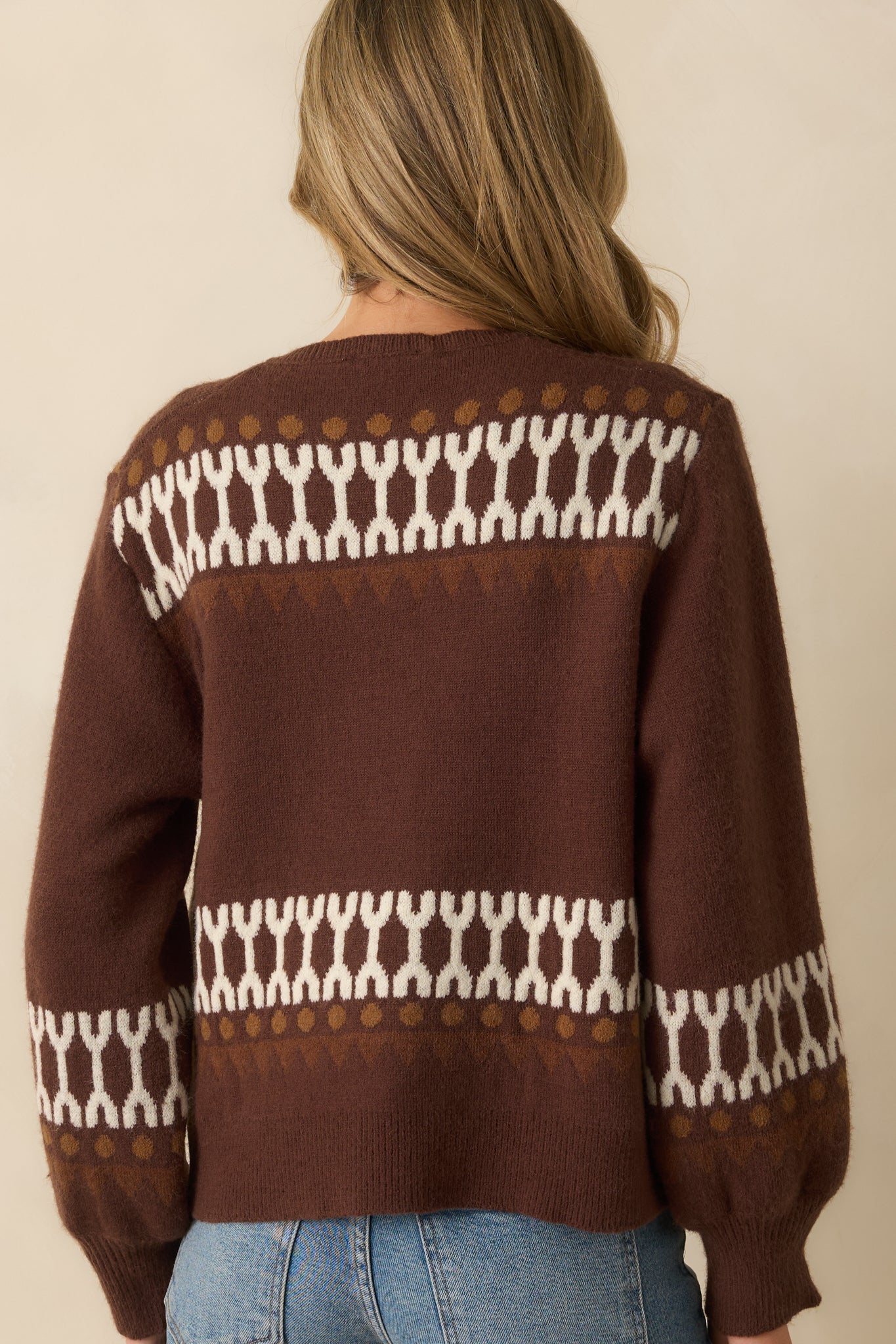 Rear view of the brown cardigan showing smooth knit fabric and ribbed hemline.