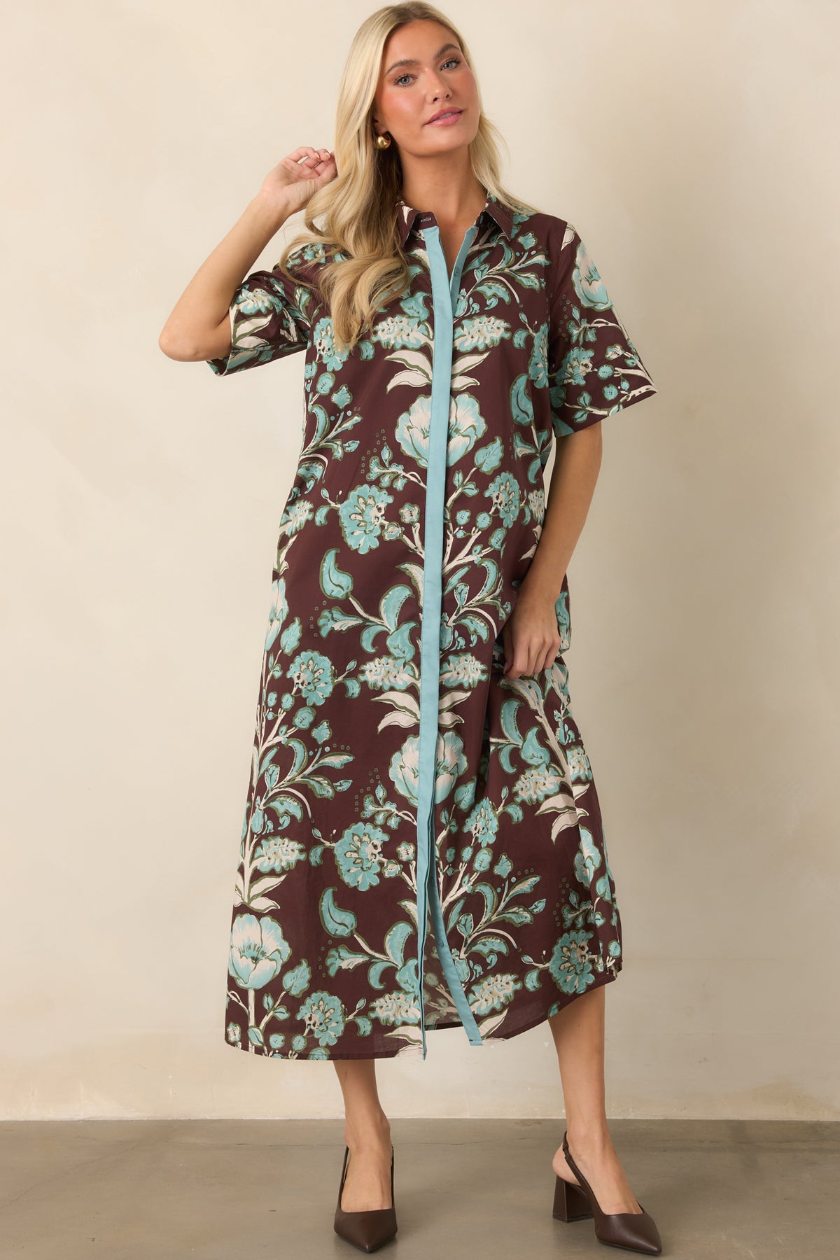 Short-sleeve cotton dress combines an earthy brown ground with aqua and ivory botanicals and practical side pockets.
