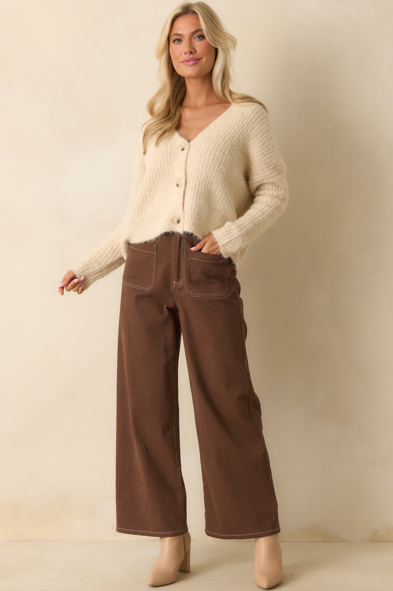 Brown cotton pants with high-rise waist and wide-leg silhouette, showing full length from waist to hem.