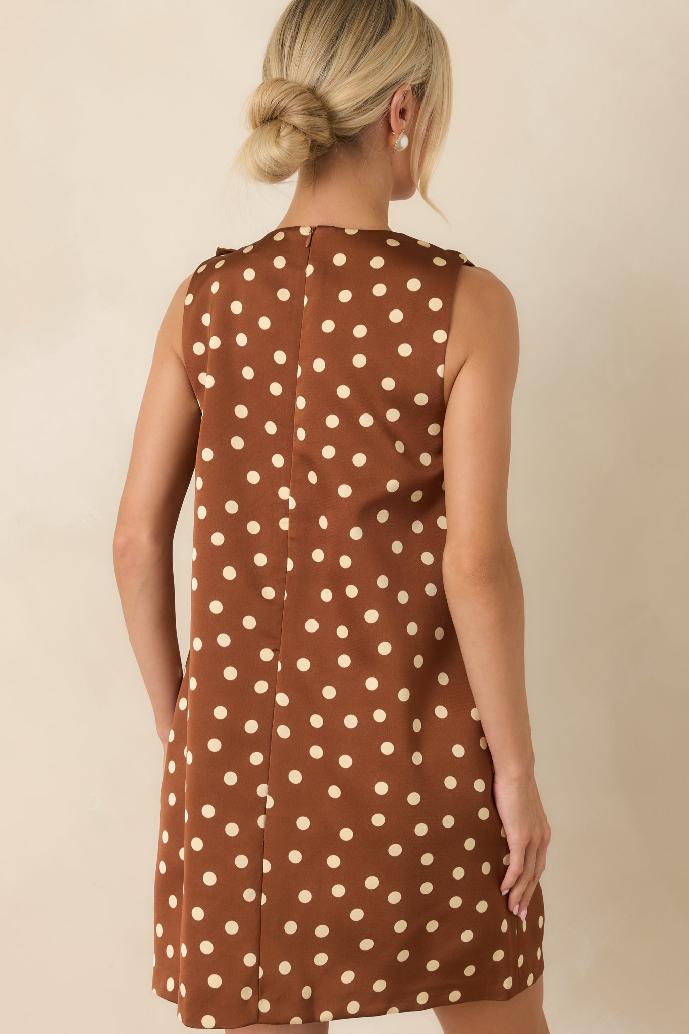 Back of the brown and cream polka dot mini dress featuring a concealed zipper and clean tailored finish.