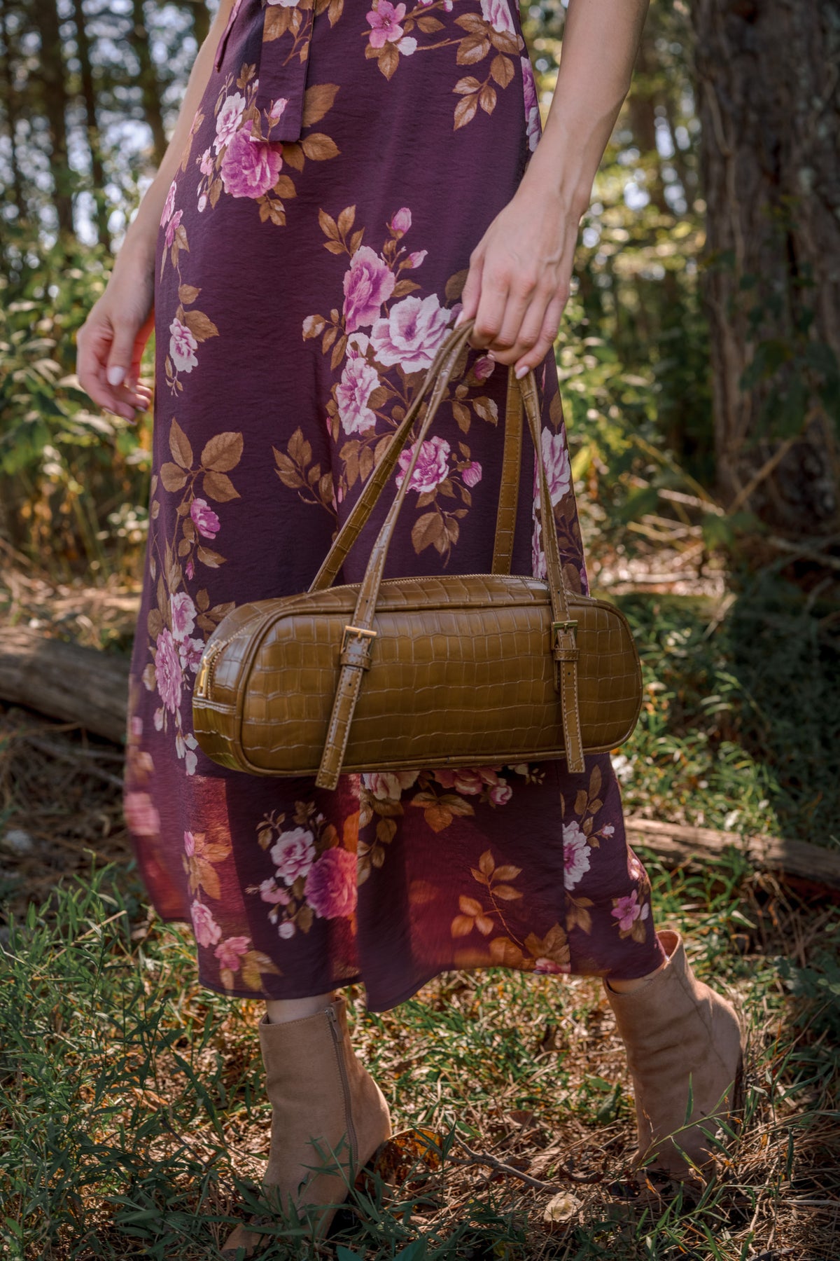 Sophisticated brown handbag featuring a textured croc-embossed exterior, sturdy top handles, elongated silhouette, and secure zip closure.