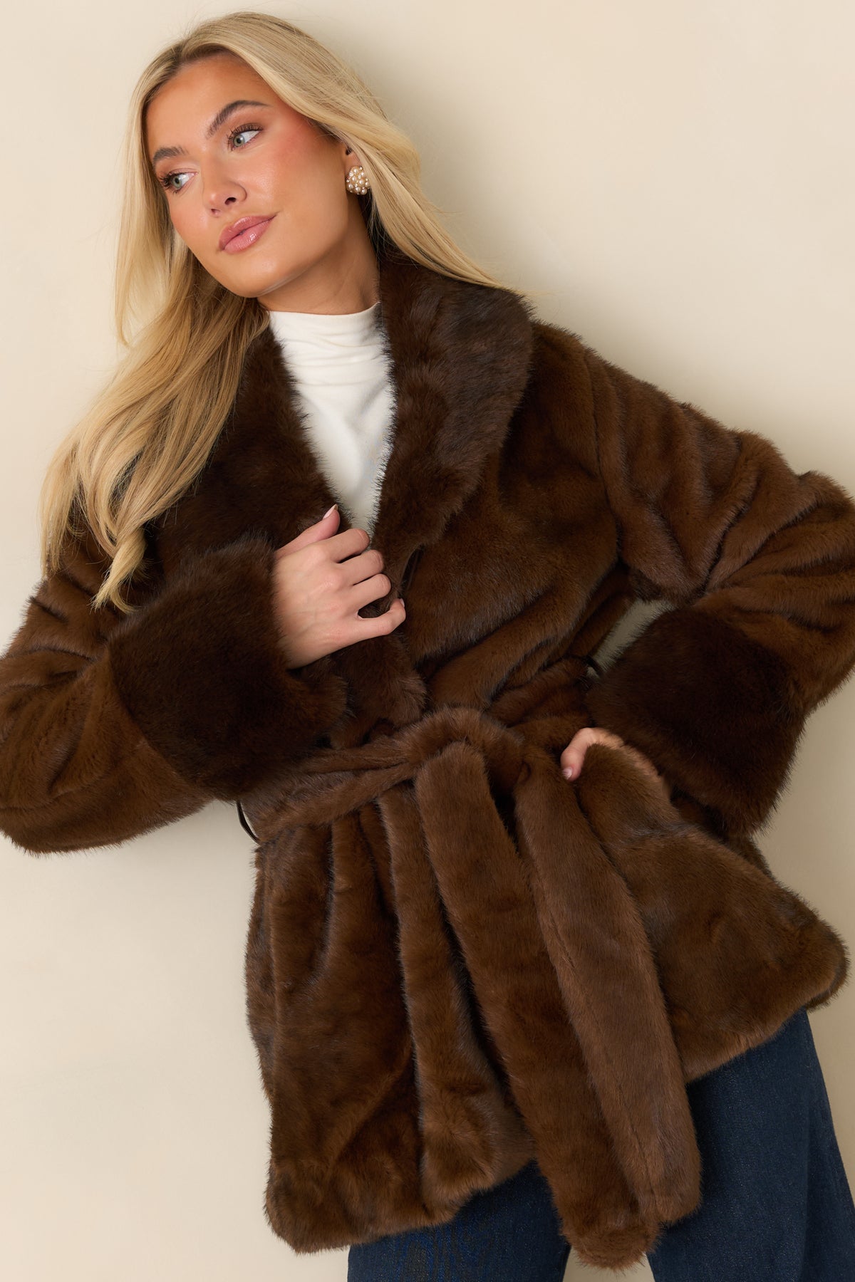 Brown faux fur coat showcasing its open-front design and thick, textured lapel collar.