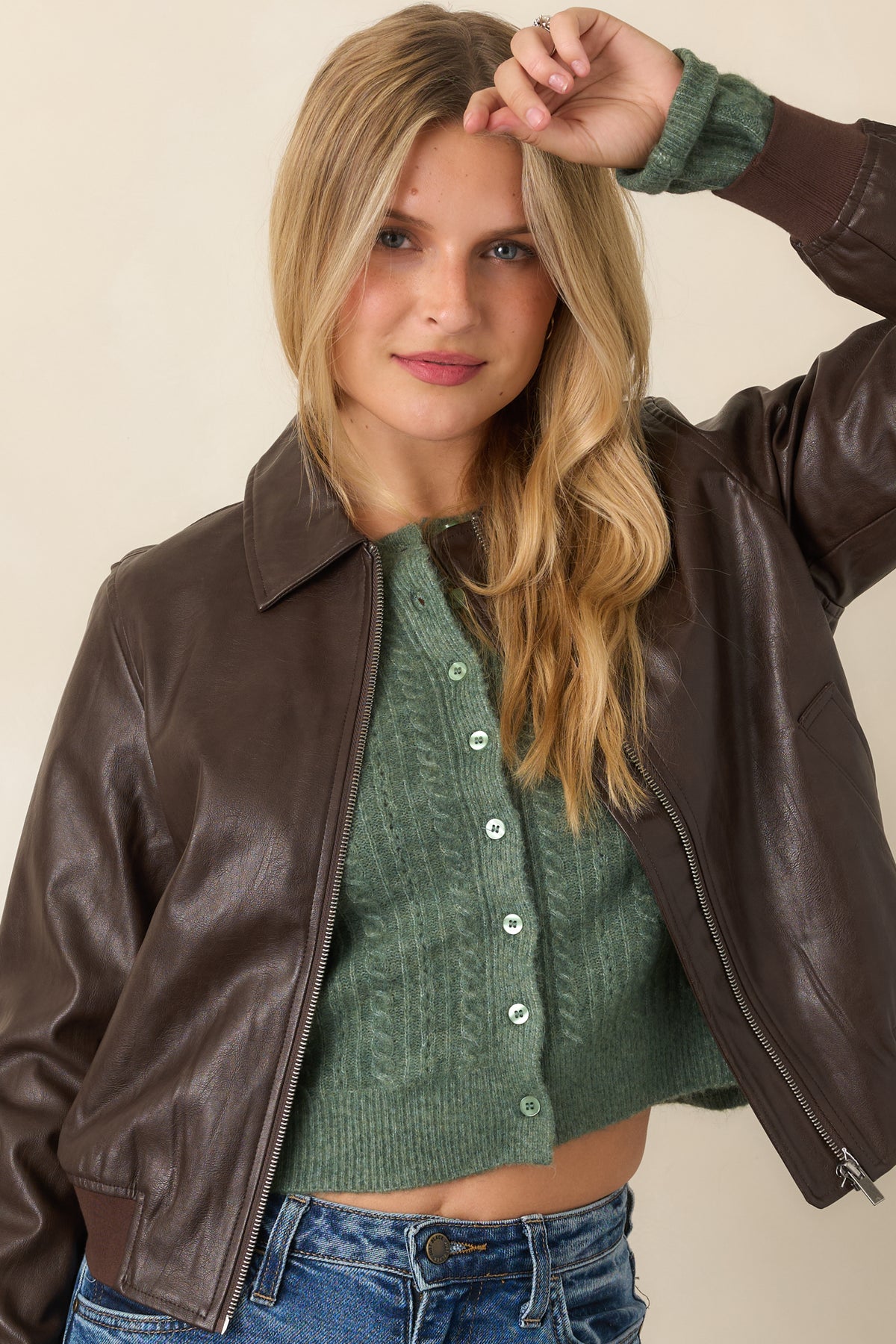 Brown faux leather jacket highlighting the collared neckline and smooth front zipper closure.