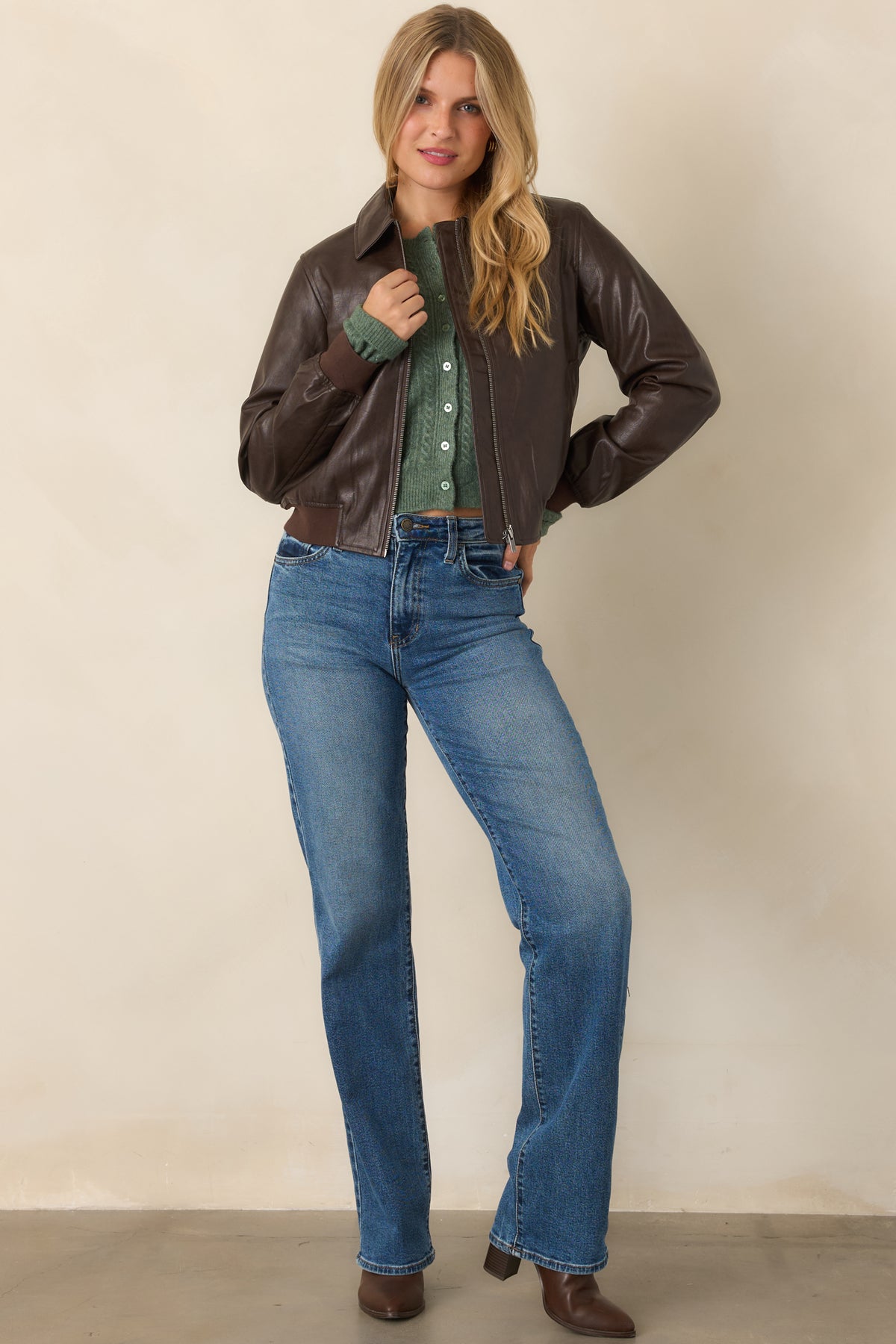 Brown faux leather bomber jacket with a structured collar, clean zip-front closure, and gently gathered ribbed hem.