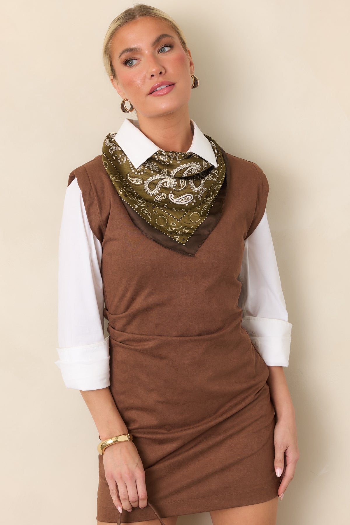 Brown faux suede-like fabric highlights the fitted bodice and gathered ruching at the waist.