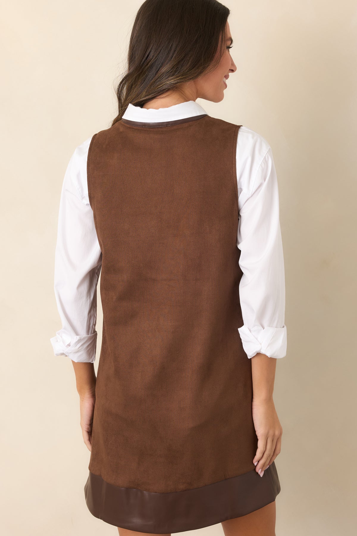 Rear of the brown faux suede mini dress showing the simple sleeveless shift silhouette and smooth finish.