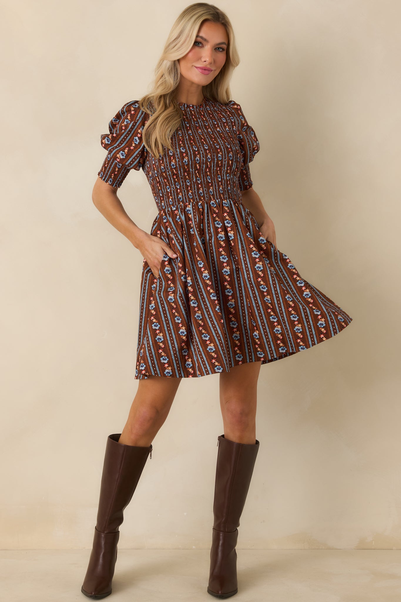 Romantic floral mini dress with a rich brown backdrop, softly flared skirt, short puff sleeves, and a subtly ruffled neckline.