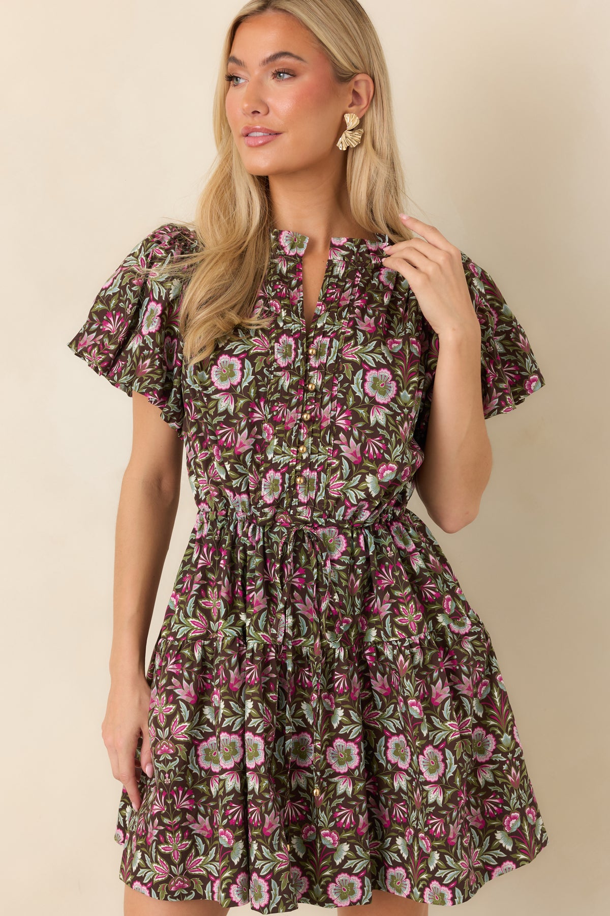 Flutter sleeves frame the upper portion of this brown mini dress, decorated with fuchsia, olive, and sage floral accents.