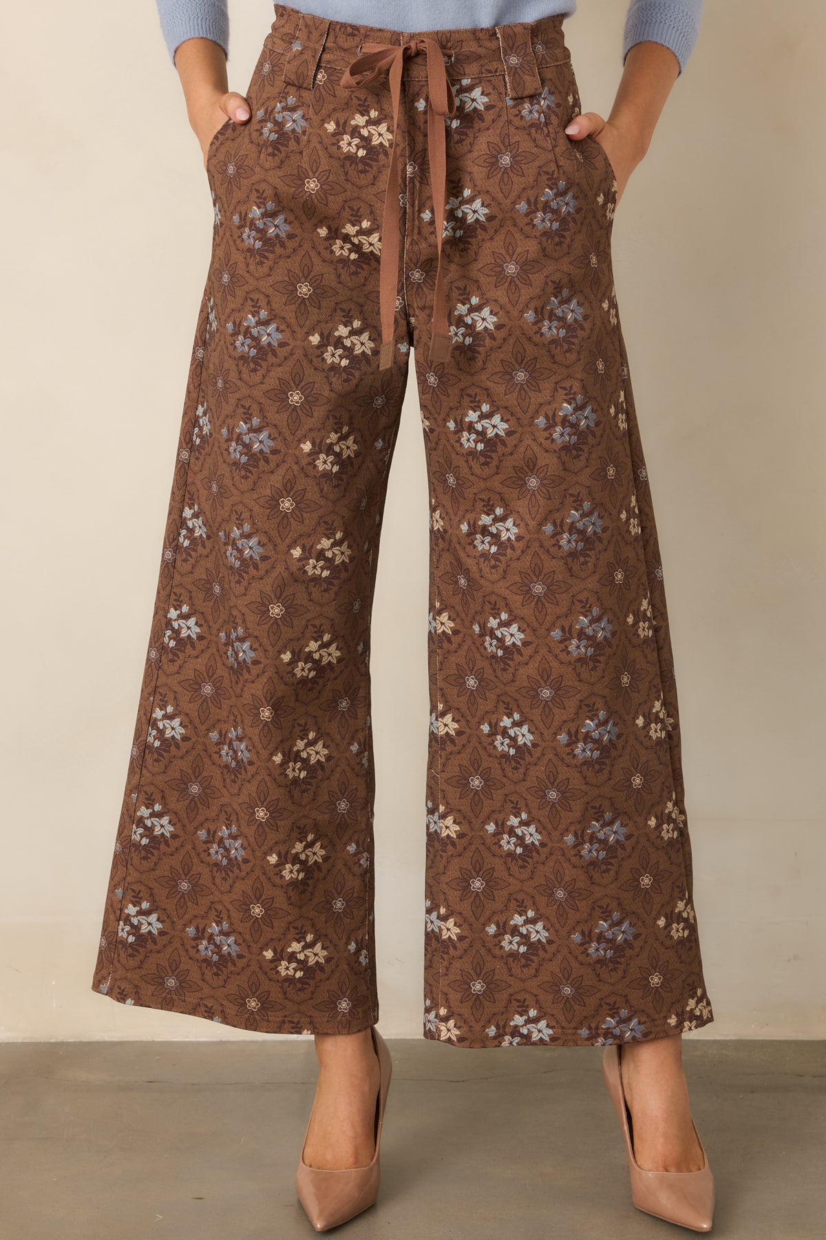 Brown floral pants highlighting the dusty blue and cream medallion pattern against a warm brown base.