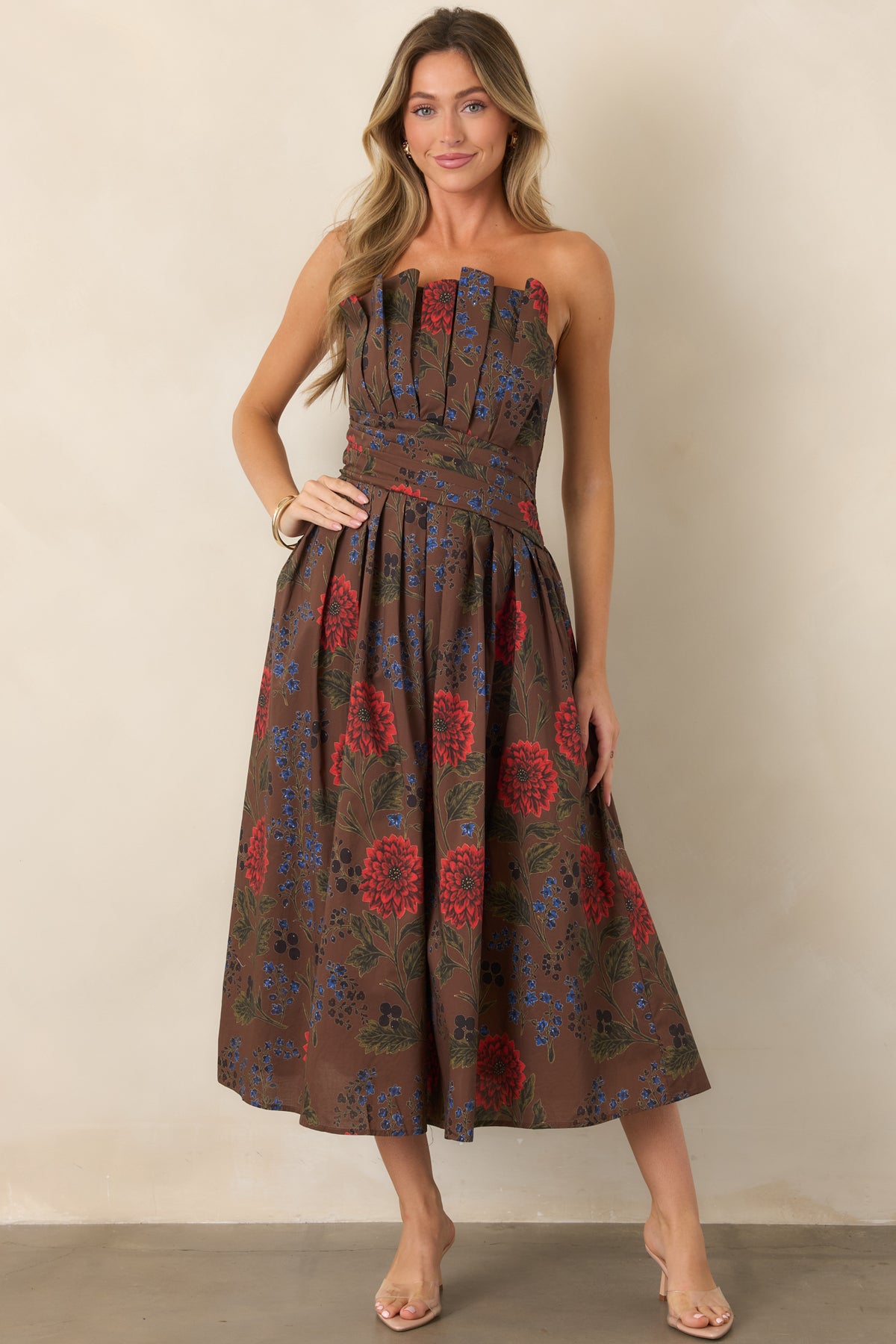 Brown floral strapless midi dress with a fitted waist and softly pleated full skirt.