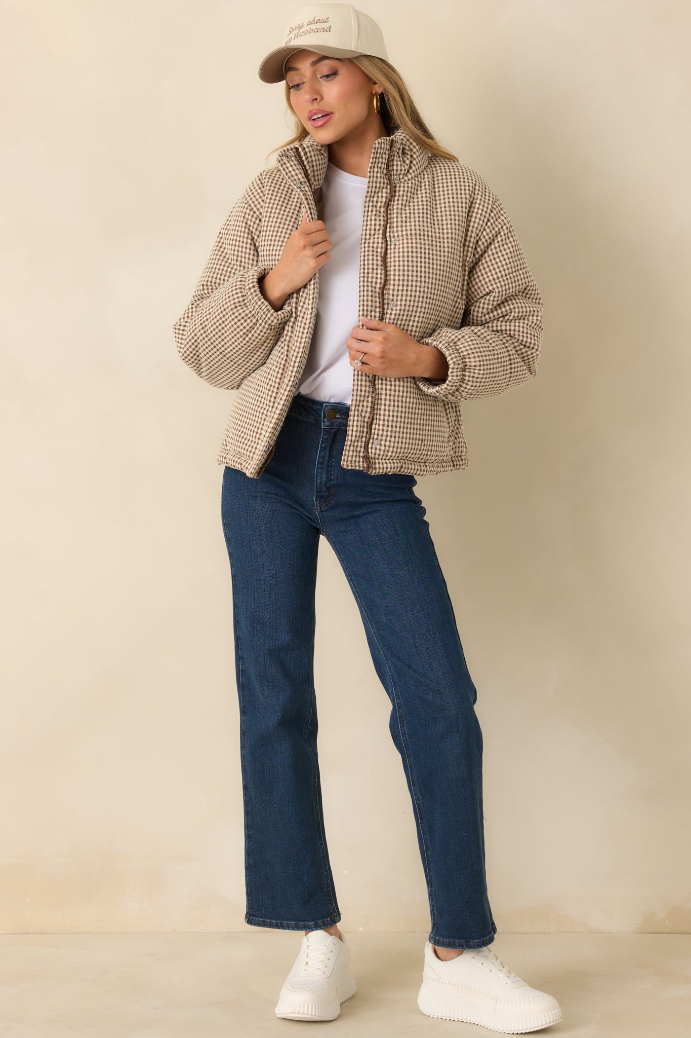 Quilted brown gingham puffer coat designed with elastic cuffs and a slightly relaxed, straight fit.