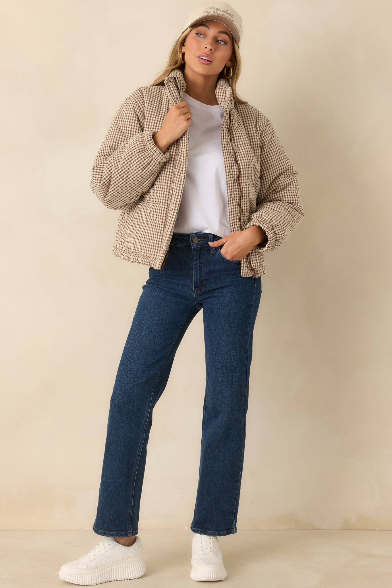 Brown gingham puffer coat with quilted construction, high neckline, and straight, relaxed silhouette.