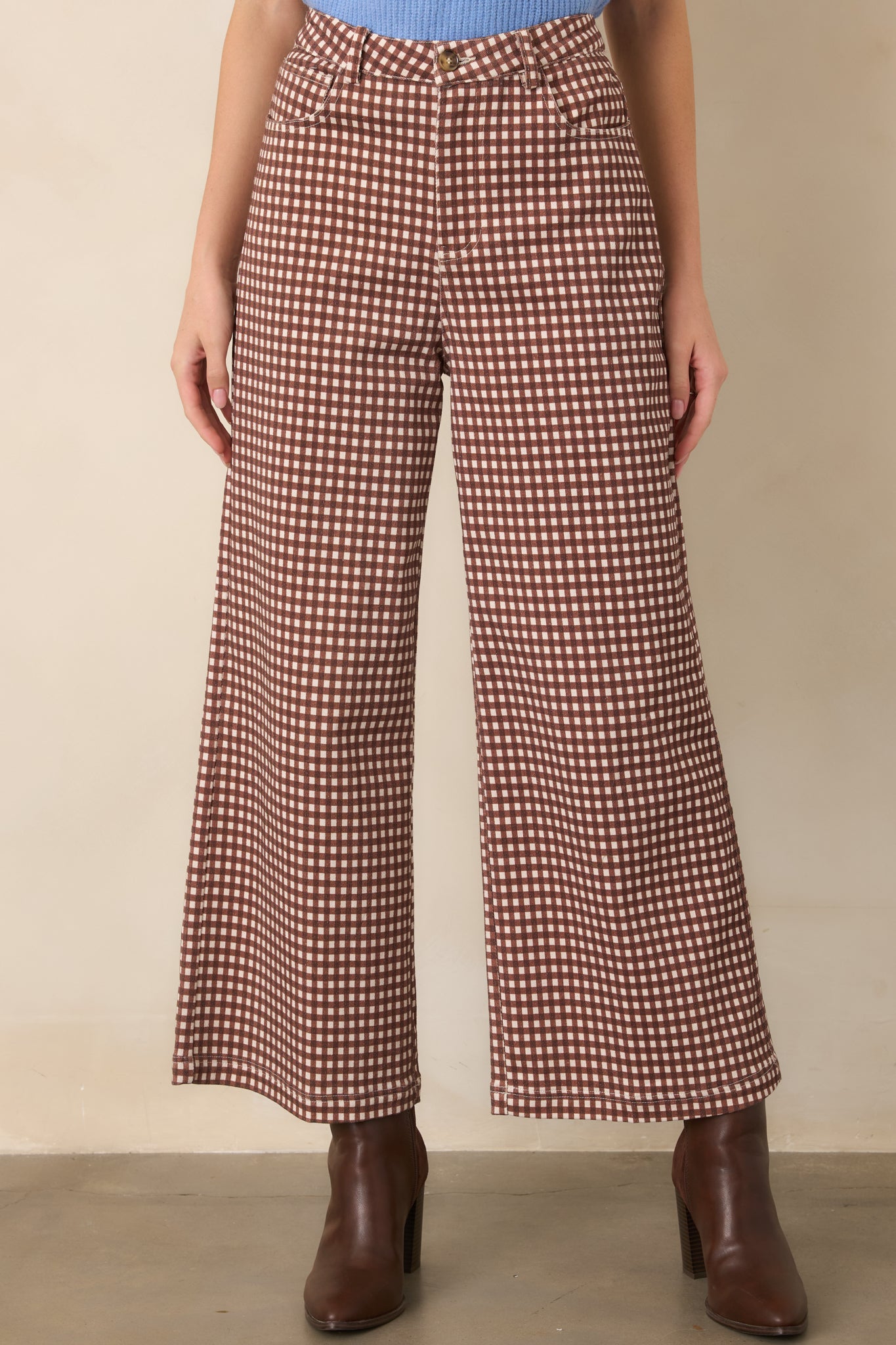 Brown and ivory gingham pants highlighting the high-rise waistband, belt loops, front closure, and crisp checkered pattern.