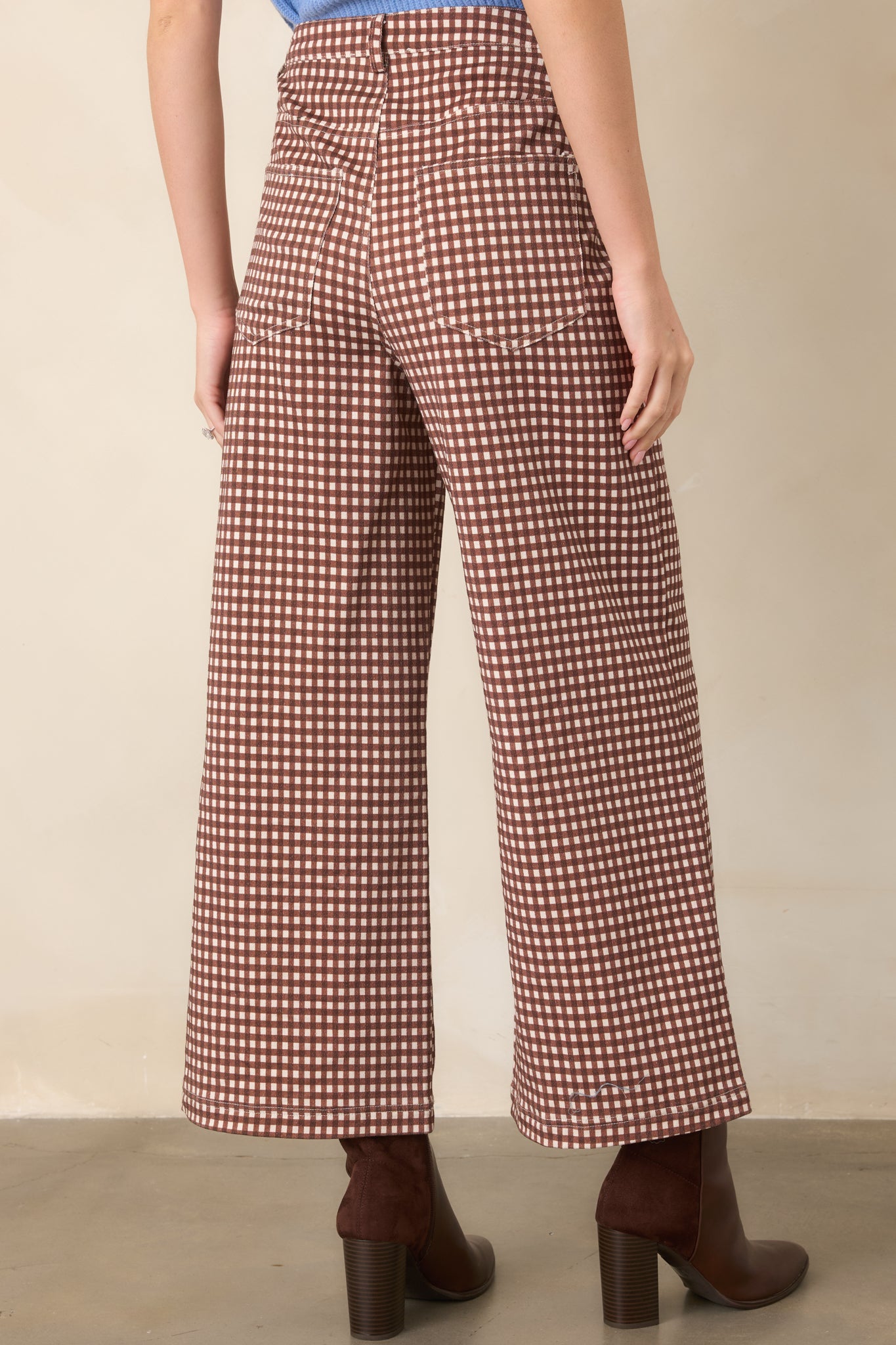 Rear view of the brown and ivory gingham pants featuring functional back pockets, belt loops, high-rise construction, and wide legs.