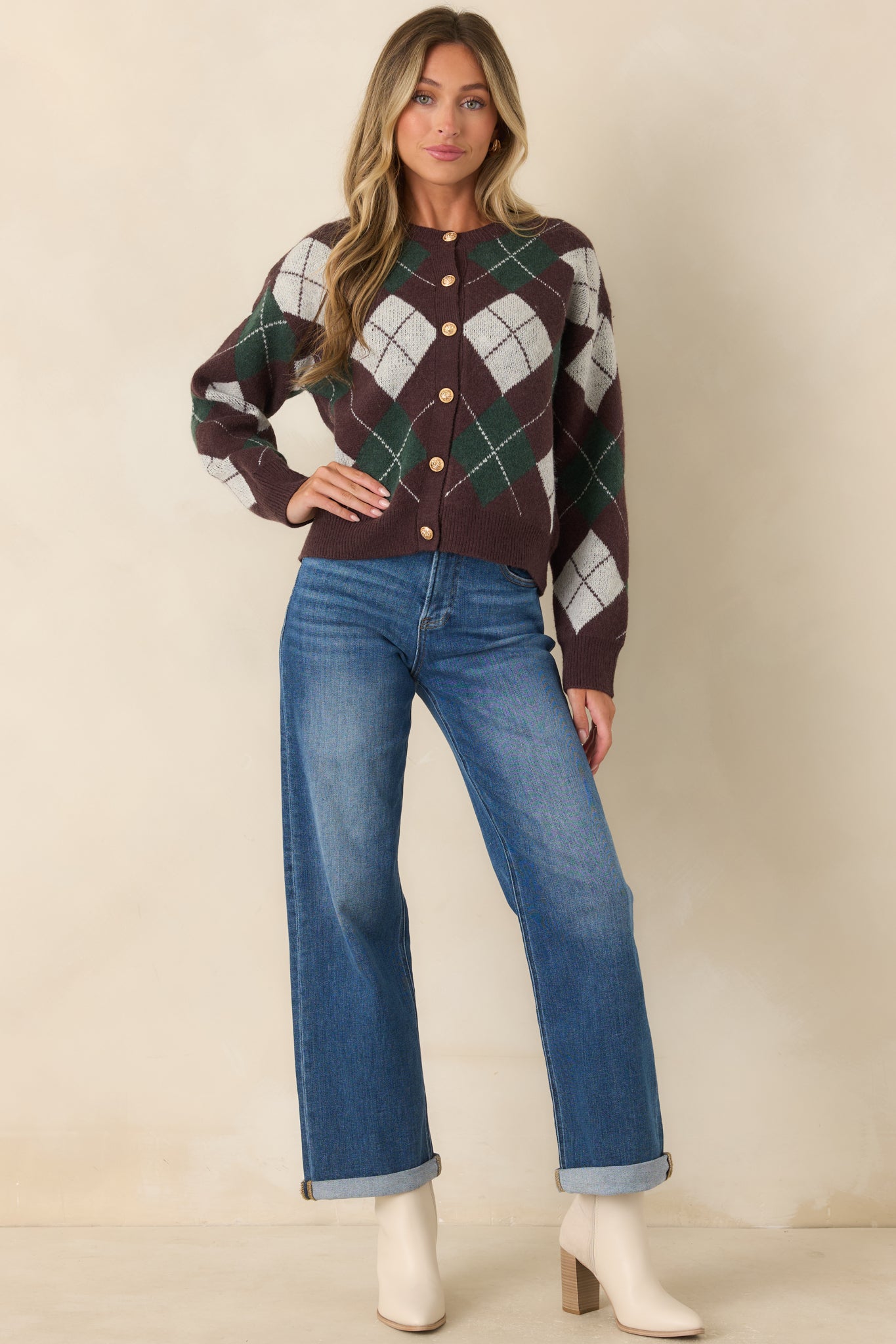 Argyle cardigan featuring deep brown, hunter green, and ivory diamonds, a functional button-front design, and a round neckline.